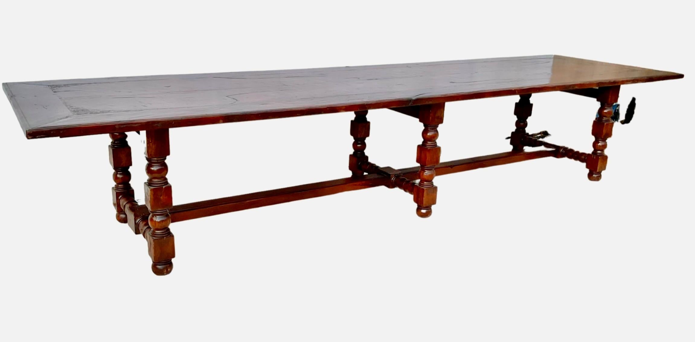 Monumental, 13 ft 6 in. long Jacobean style mahogany dining table. Large enough to easily serve a party of 12 to 14 people, in supreme comfort. Raised on 6 turned baluster supports joined by a central H stretcher. Designed for a grand room and seats