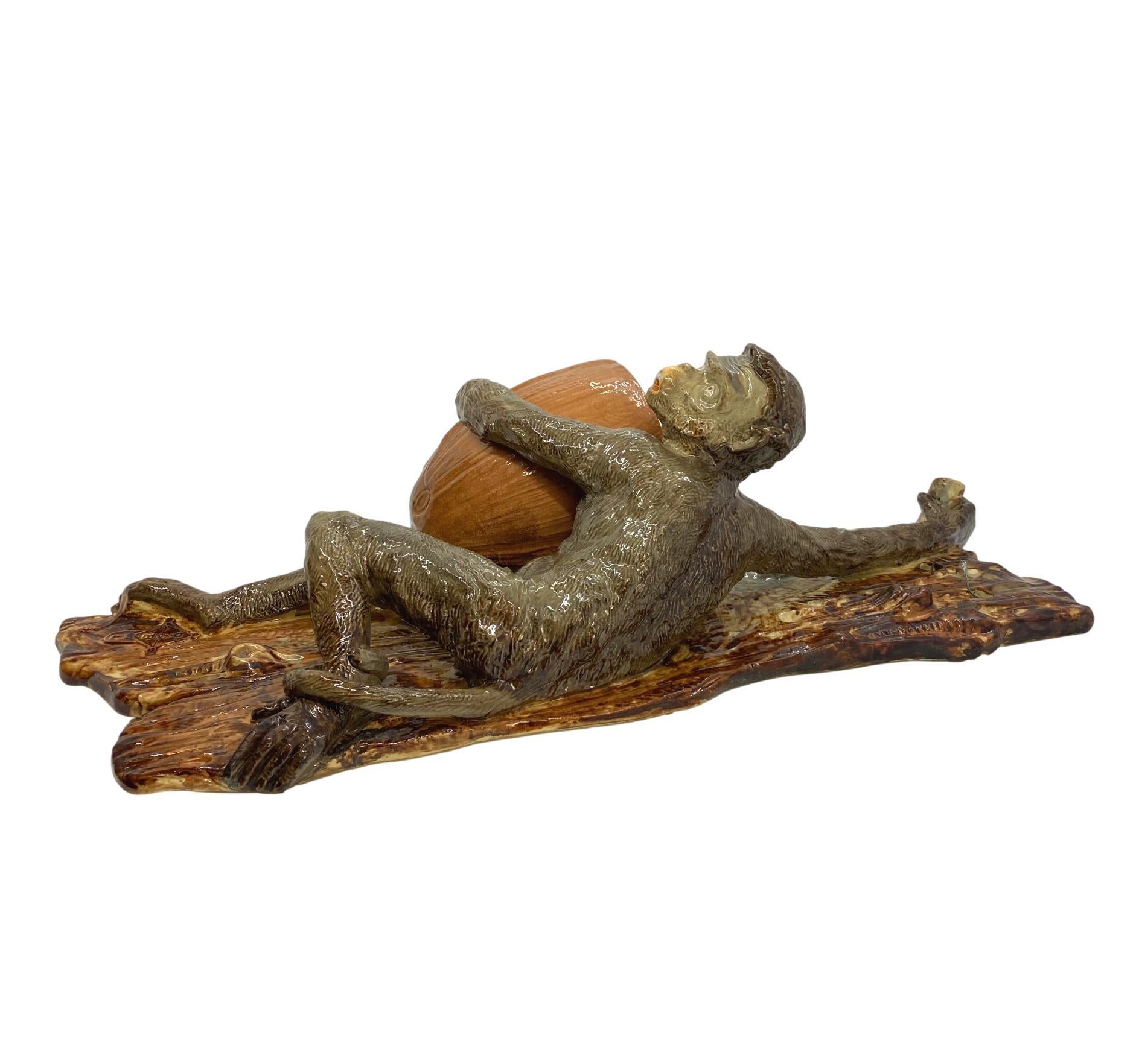 Wayte & Ridge Majolica Monkey wall pocket, 18 inches high, English, ca. 1860, molded as a monkey climbing a tree, holding a simulated coconut forming the flower bowl, with molded lozenge below the monkey's right foot, 'W & R L,' for Wayte & Ridge,
