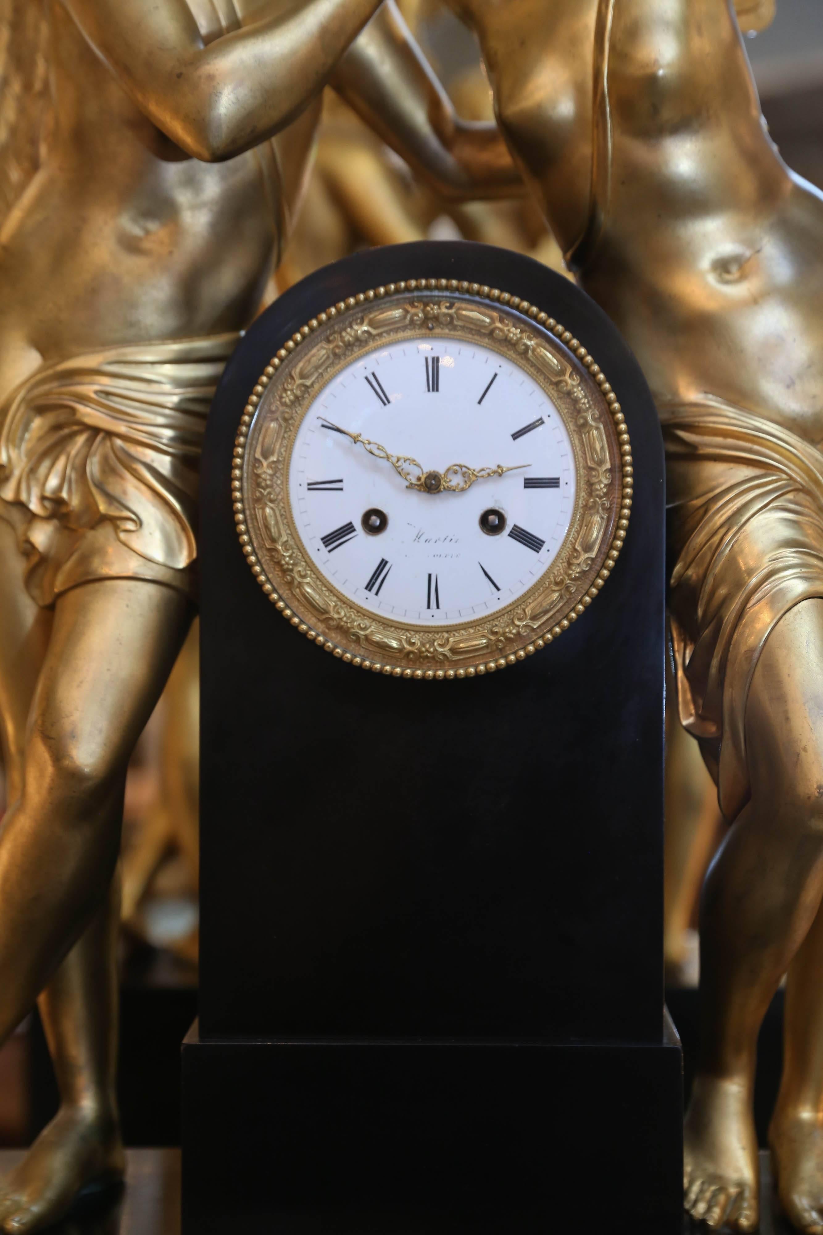 Amazing clock depicting the tale of Amor and Psyche which
Is about the god of love in Greek mythology. Large bronze
Dore figures adorn the pediment standing on a rectangular
Marble base. It has an enamel face marked with Roman numerals. On the