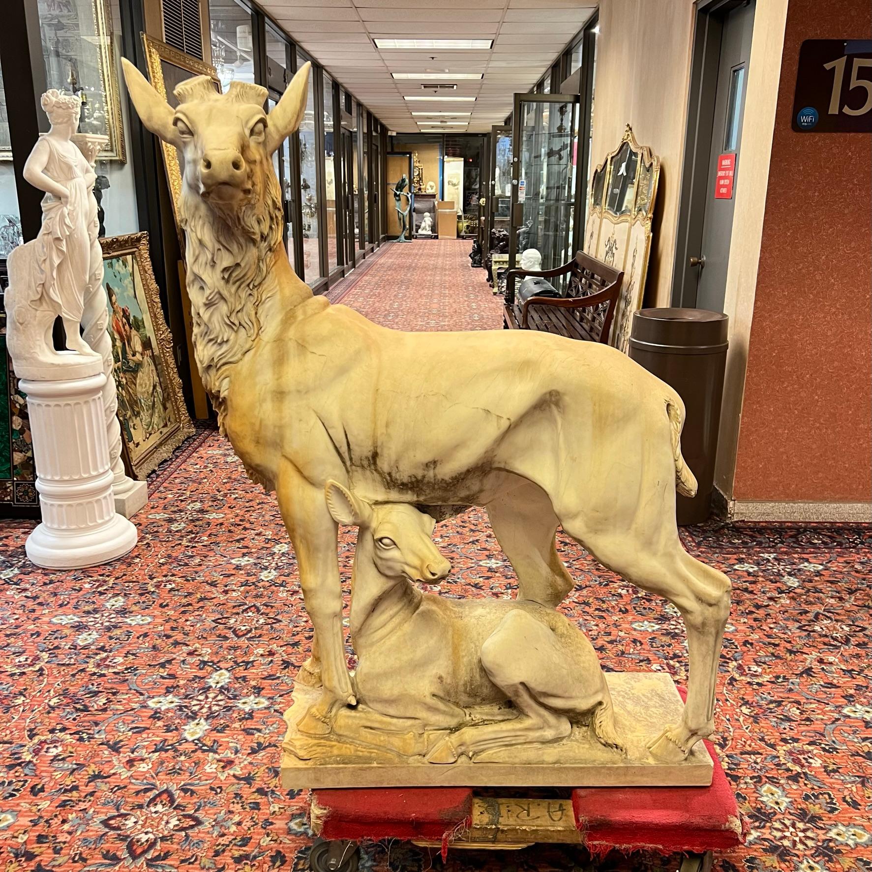 Our monumental marble sculpture of a standing buck deer and fawn at his feet measures 53 inches tall and dates from the late 19th century. Apparently unsigned. In good condition with weathered surface from exhibition outdoors.