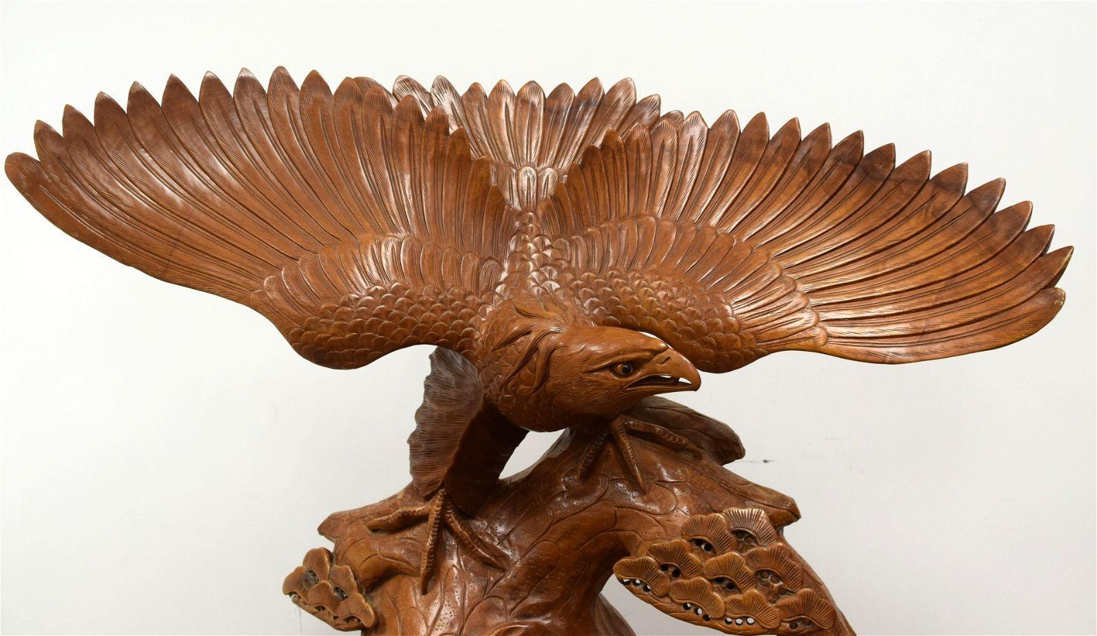 Very large Japanese Meiji period and finely sculpted figure of an eagle carved from teak with burlwood stand.  In excellent condition.  Apparently unsigned.
Sizes are over all the eagle alone is 35