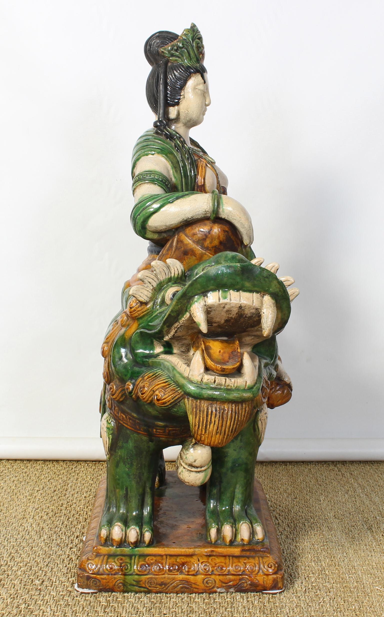 Chinese Monumental Mid-20th Century Glazed Ceramic Quan Yin Astride a Foo Dog