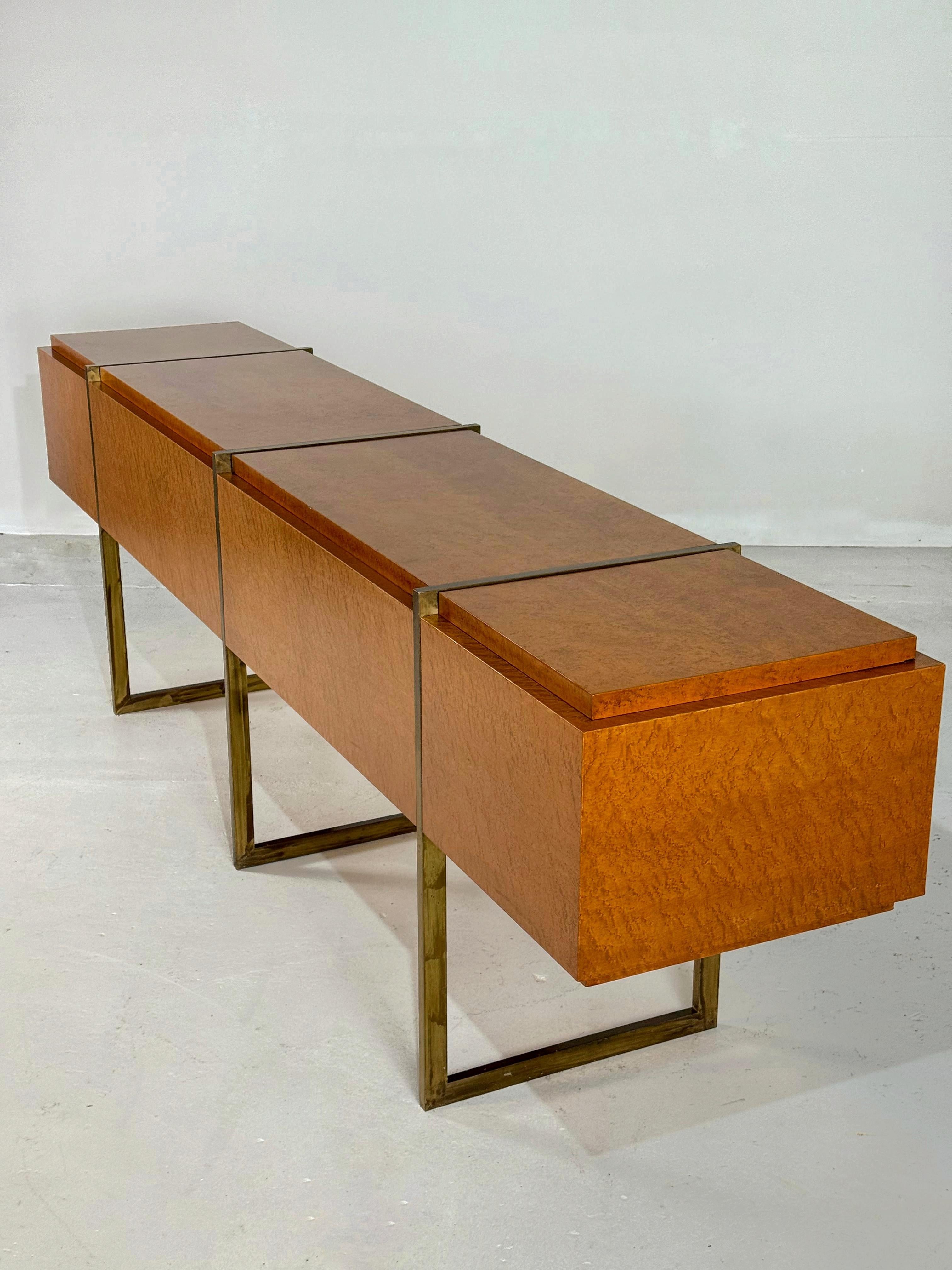 A truely unique sideboard/credenza in rich burlwood and brass legs.

In absolute perfect, refinished condition.

Can be used as a sideboard against a wall or as a centerpiece in a giant room or hallway.

All sides are finished in burlwood.

Inside a