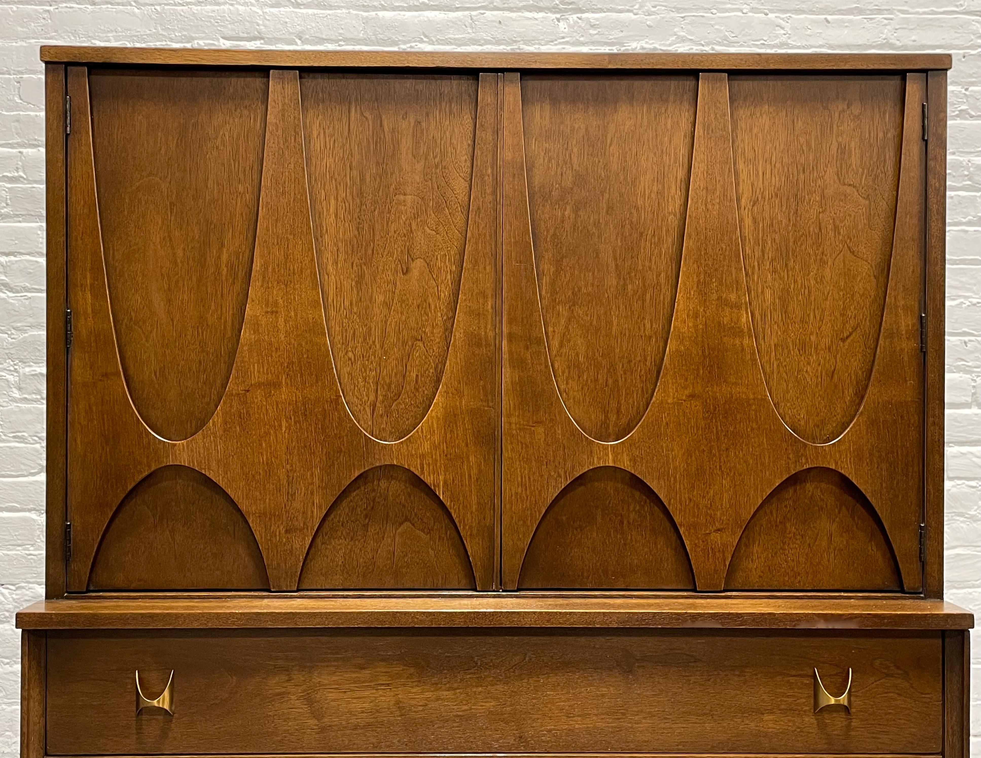 Mid Century Modern Broyhill Brasilia Dresser, circa 1960s. This is a magnificent dresser from the much beloved and voraciously collected Brasilia collection. From the distinctive elongated, inverted sculpted arches to the brass hand pulls, this