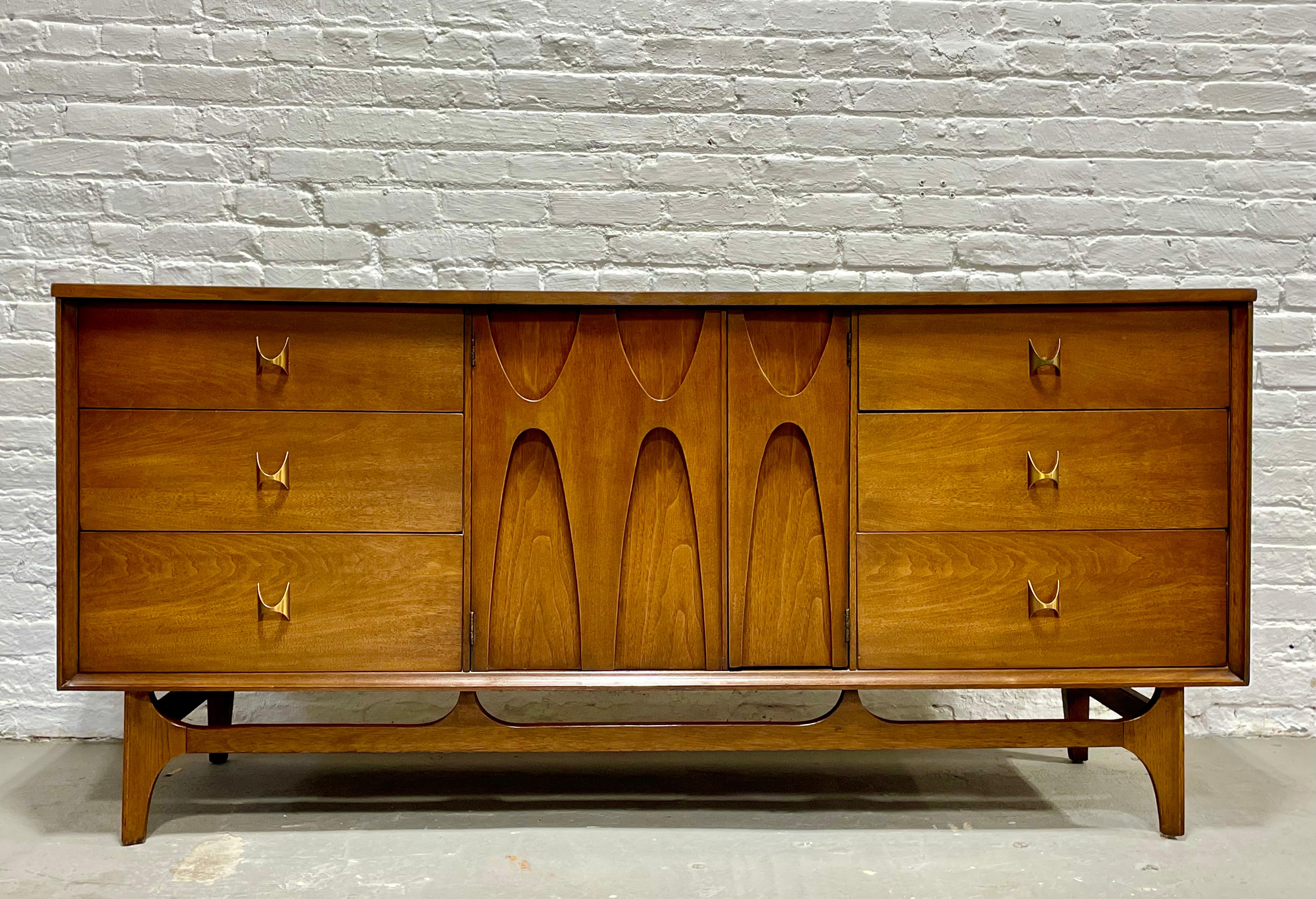 Mid-Century Modern Broyhill Brasilia Dresser, circa 1960s. This is a magnificent dresser from the much beloved and voraciously collected Brasilia collection. From the distinctive elongated, inverted sculpted arches to the brass hand pulls, this
