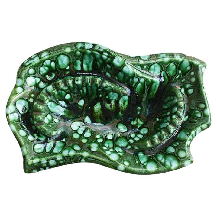 A monumental malachite look ceramic ashtray. Created from ceramic, this beautiful piece is enormous! It will be fabulous on a nightstand or coffee table used as a catchall or trinket dish. The underside is textured in faux bois finish and glazed in