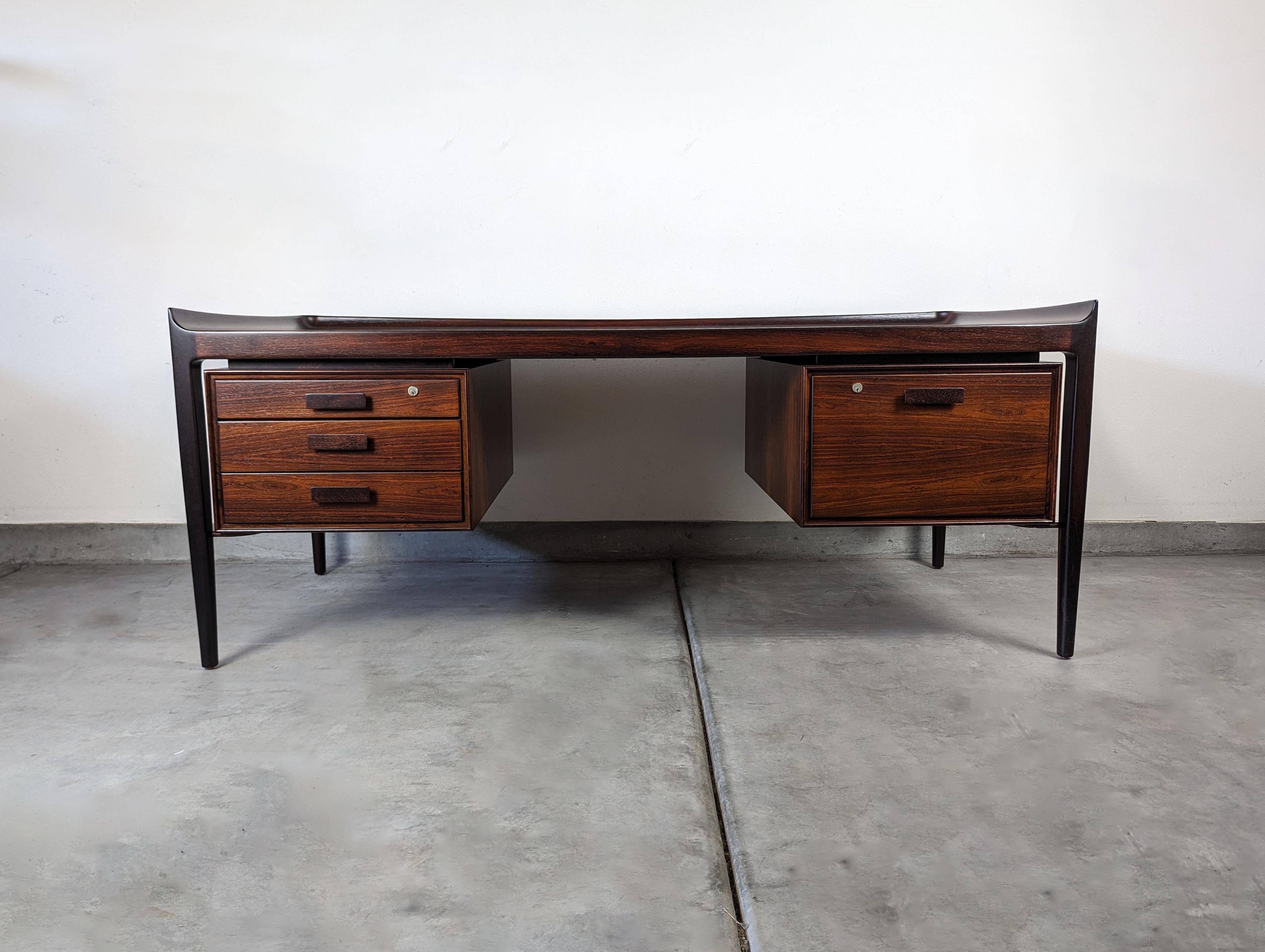 The Monumental Rosewood Scandinavian Desk is an exquisite piece of furniture that seamlessly blends elegance, functionality, and the timeless beauty of rosewood. Crafted with meticulous attention to detail, this desk is a true testament to