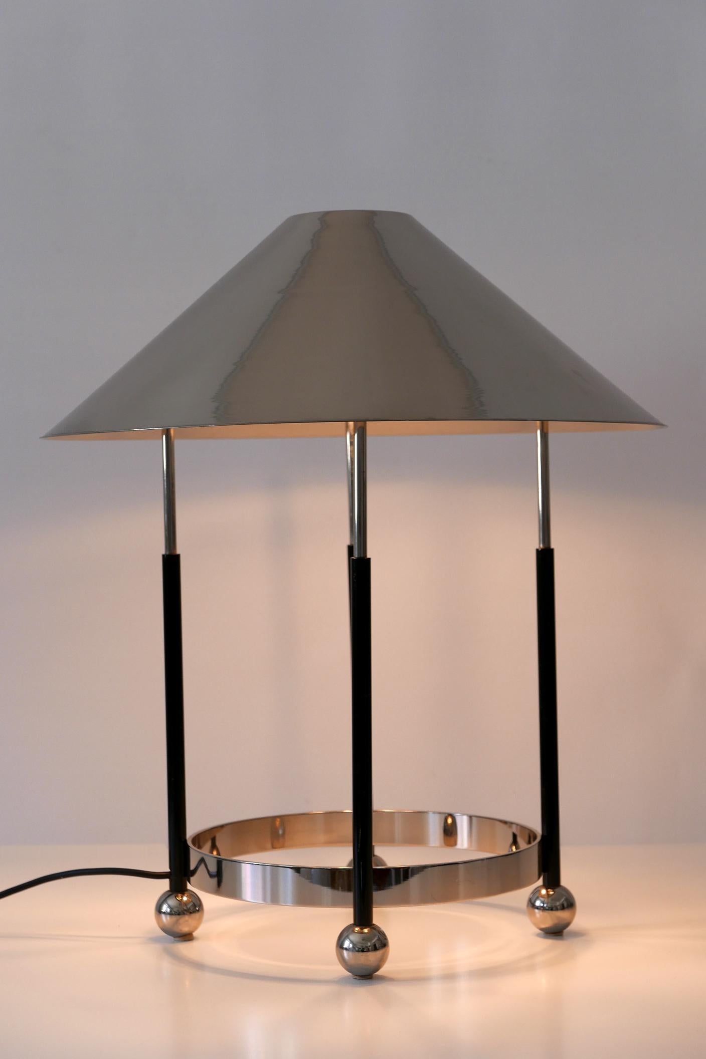 Gorgeous, exceptional and big Mid-Century Modern table lamp. Designed and manufactured probably in 1970s, Germany.

Executed in nickel-plated and partly black enameled brass, the lamp comes with 2 x E27 / E26 Edison screw fit bulb sockets, is wired,