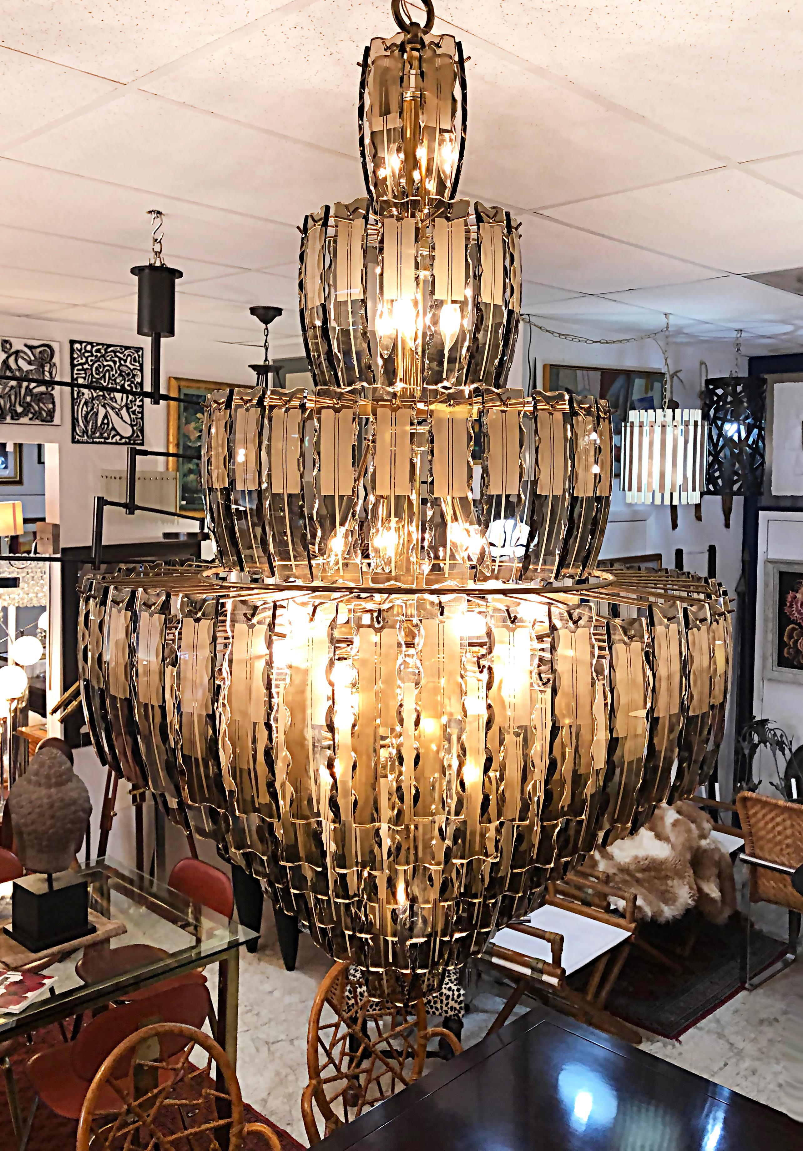 Monumental Mid-Century Modern tiered chandelier with amber tinted glass crystals.

Offered for sale is a monumental Mid-Century Modern tiered chandelier with amber-tinted glass crystals. The chandelier will drop over 5 feet and can be hung with a
