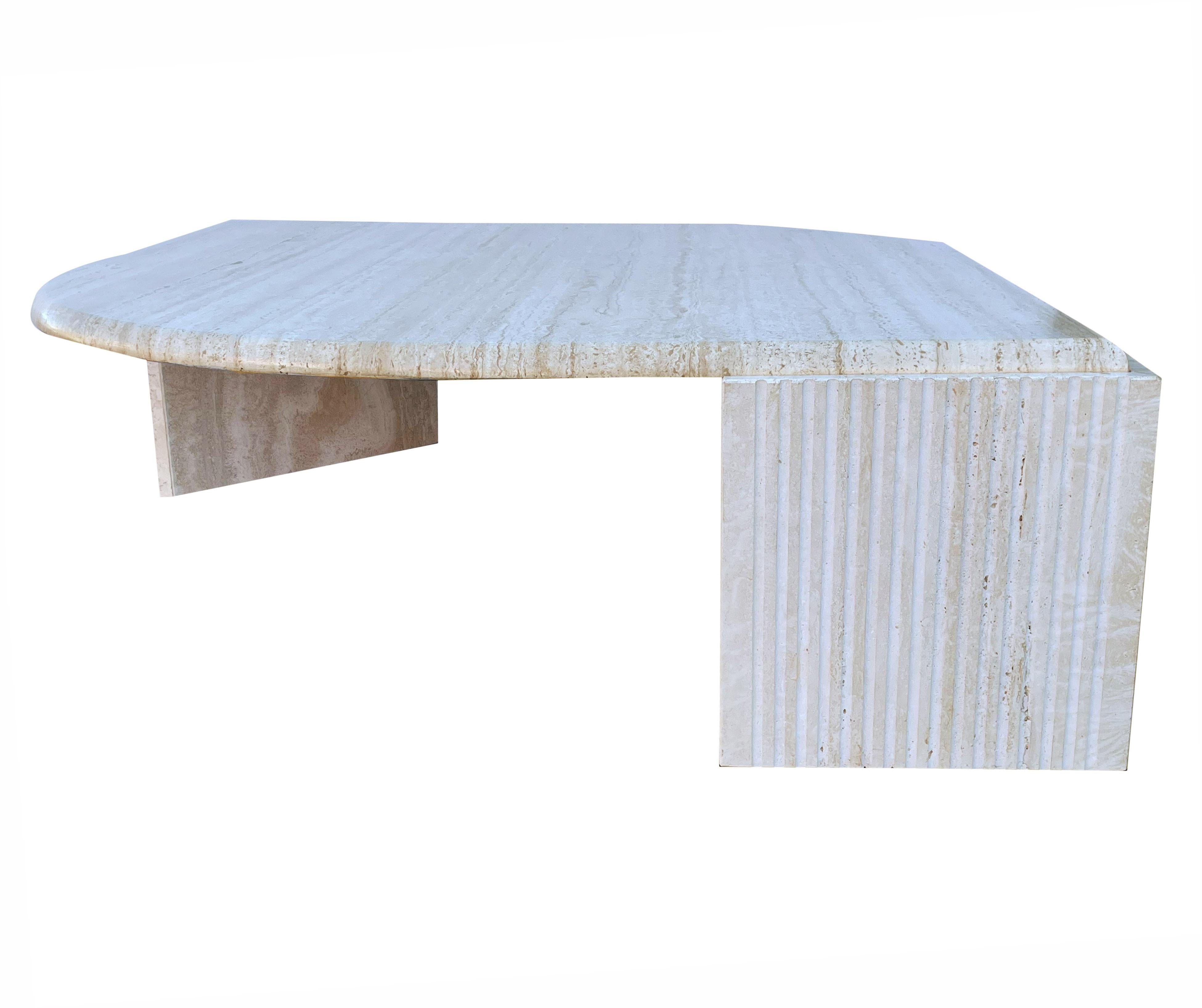 A larger scale and substantial cocktail table from Italy, circa 1980s. The piece is constructed of two base parts with a large honed travertine top. In excellent overall condition.
