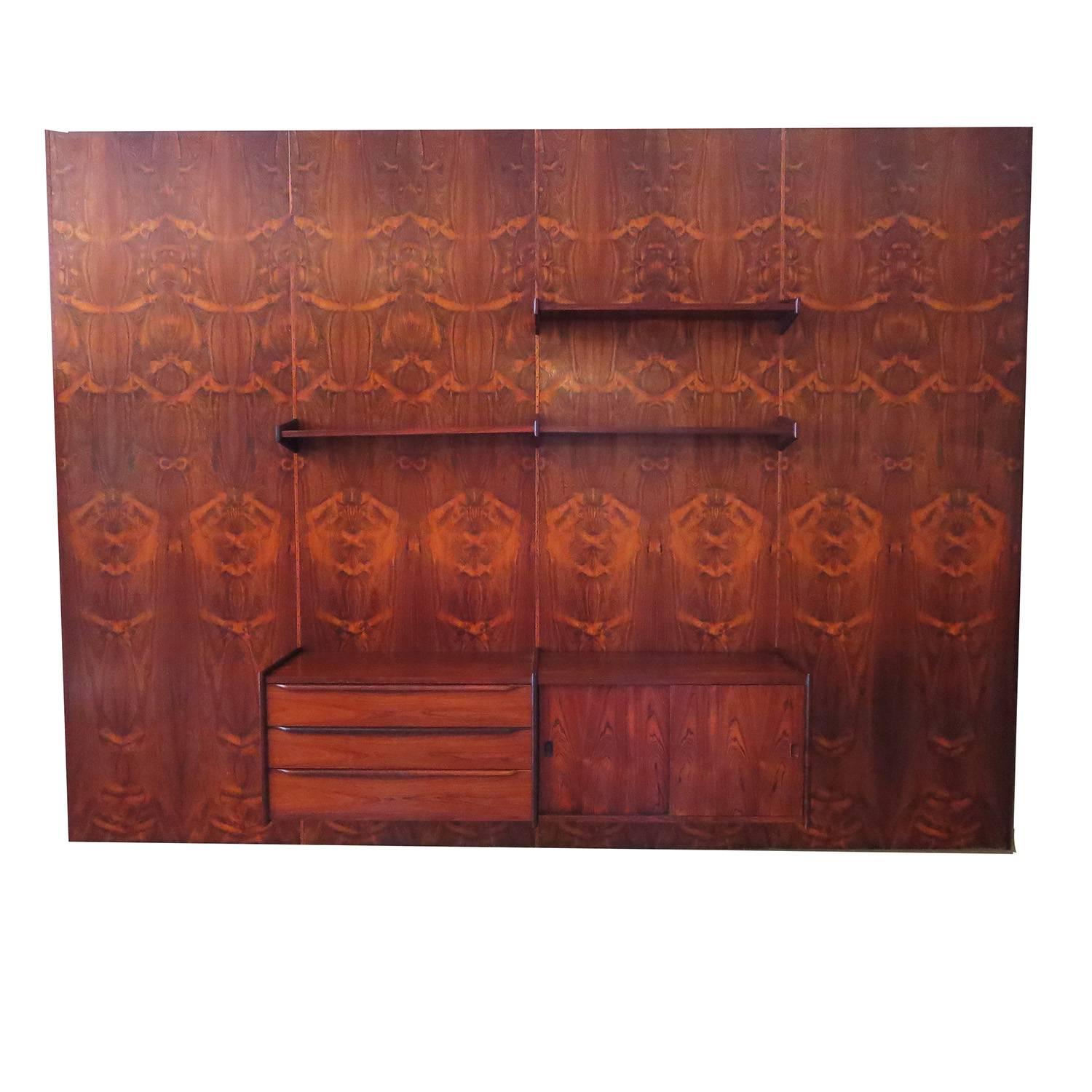 There are a few of these European wall units that have come on the market, but none that can equal the beautiful grain pattern of this rosewood. The unit consists of four bookmatched panels of highly figured rosewood, plus a thinner panel (not