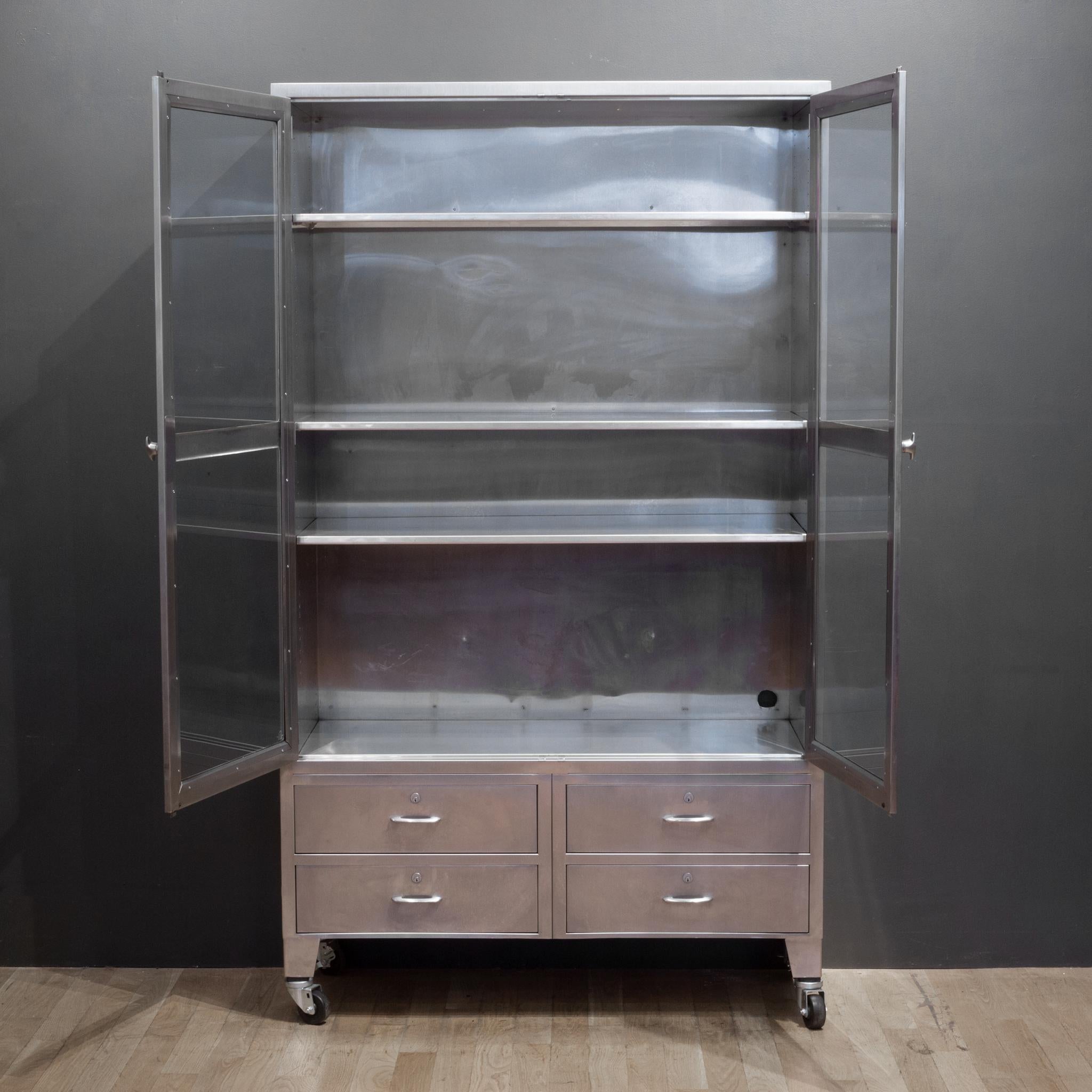 About:

An original large stainless steel medical or dental cabinet on casters with glass doors, three adjustable shelves and four drawers. The back casters have locks.

 Creator: Unknown.
 Date of manufacture: circa 1950.
 Materials and