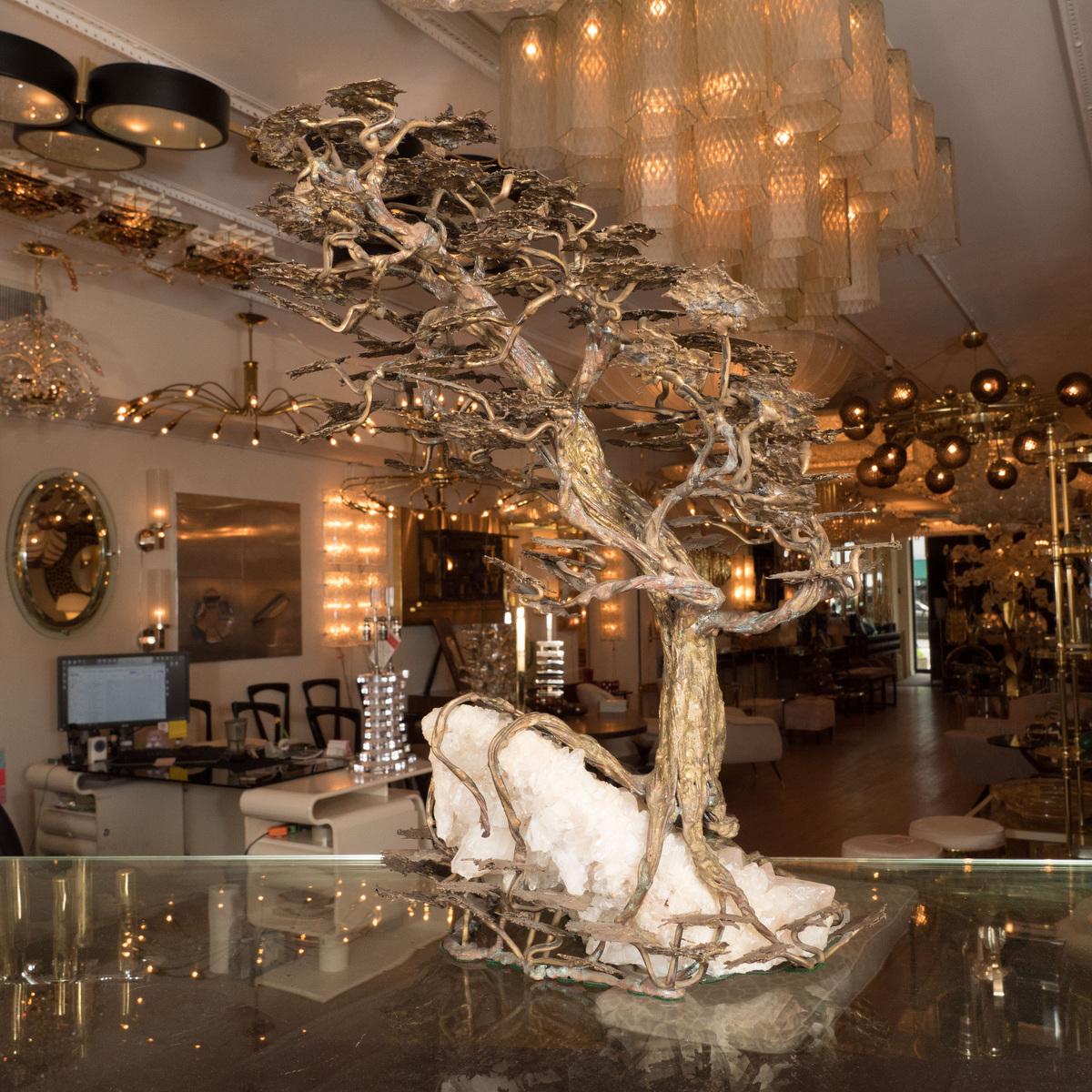 Monumental mixed metal tree sculpture on a rock crystal base.