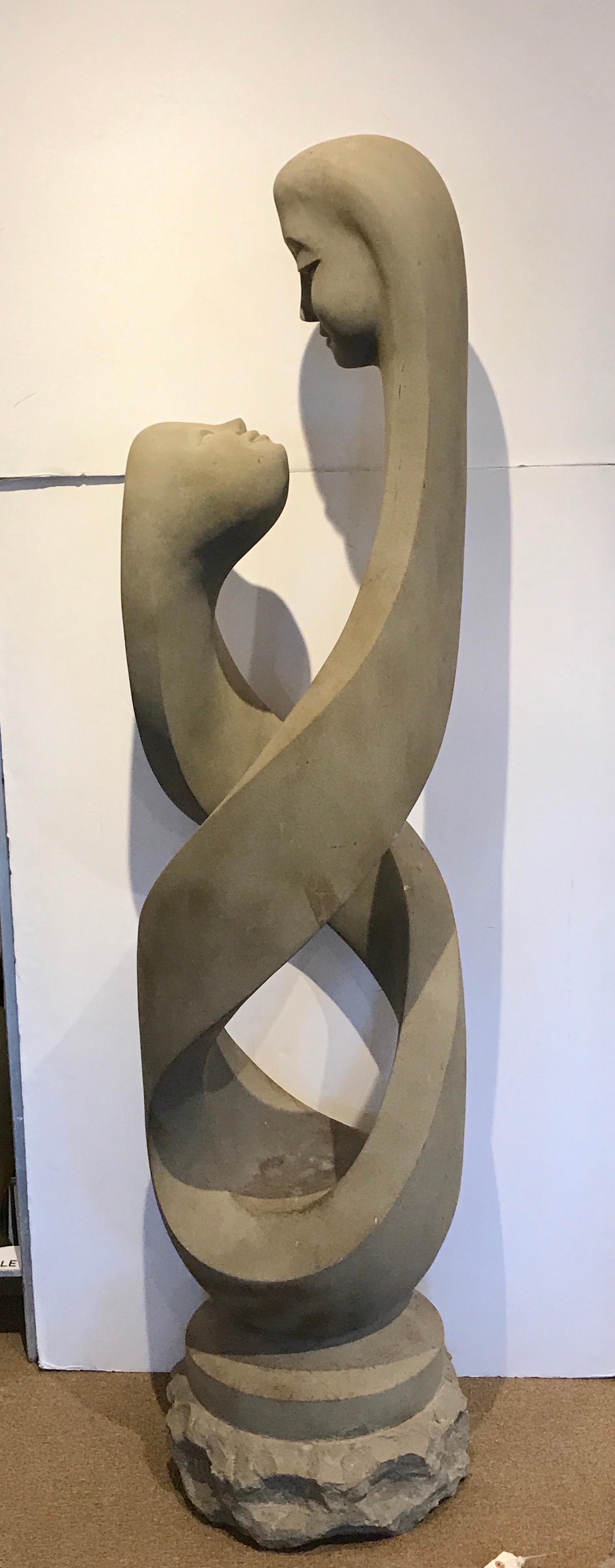 Monumental modern carved limestone spiral sculpture, with two figural heads facing each other. Standing 76