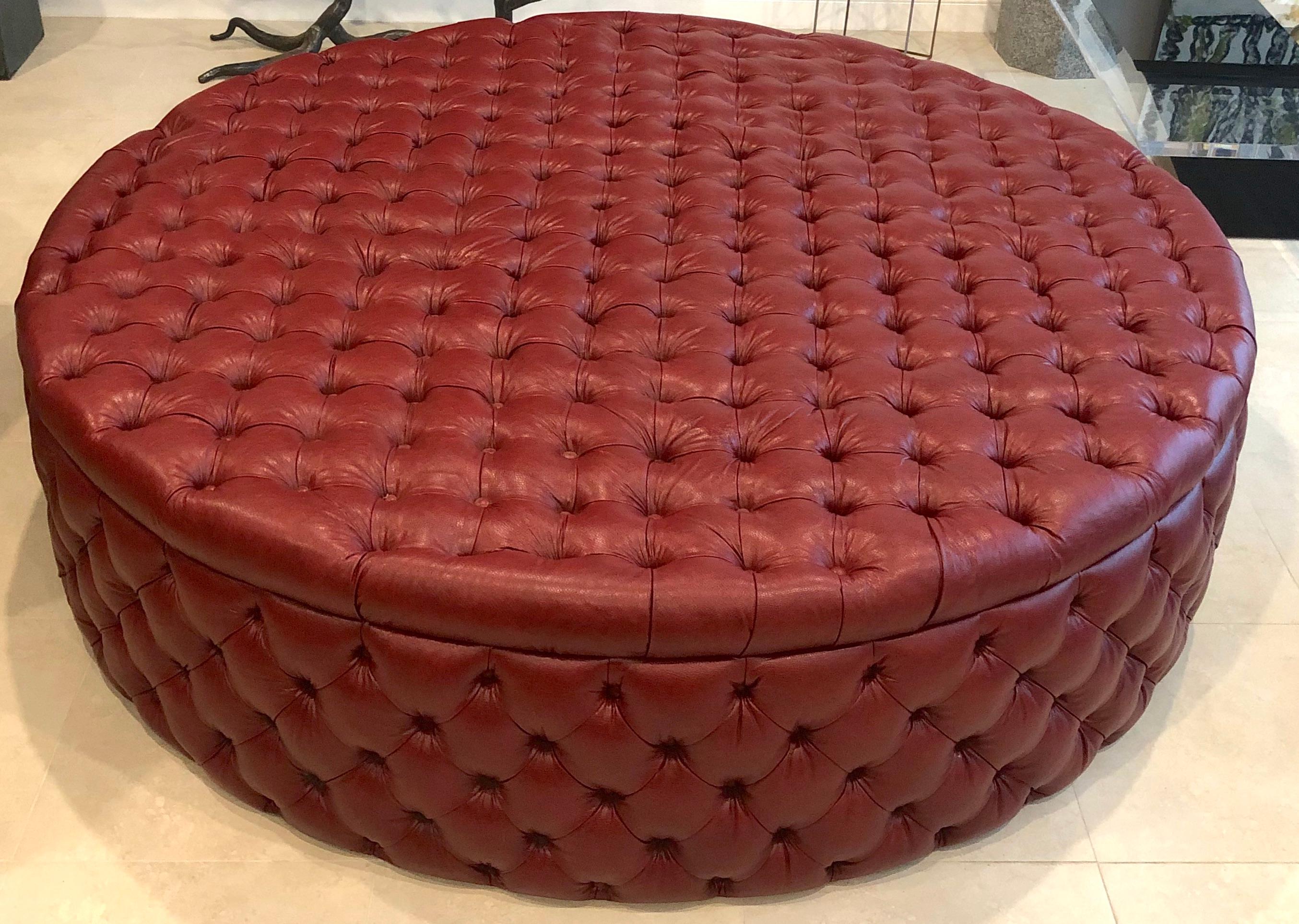 Monumental modern English oxblood leather circular ottoman, beautiful specimen grade oxblood tufted leather on a 80-inch diameter x 22-inch high framed ottoman. A hard to find, large scale previously owned custom made ottoman. One piece construction.