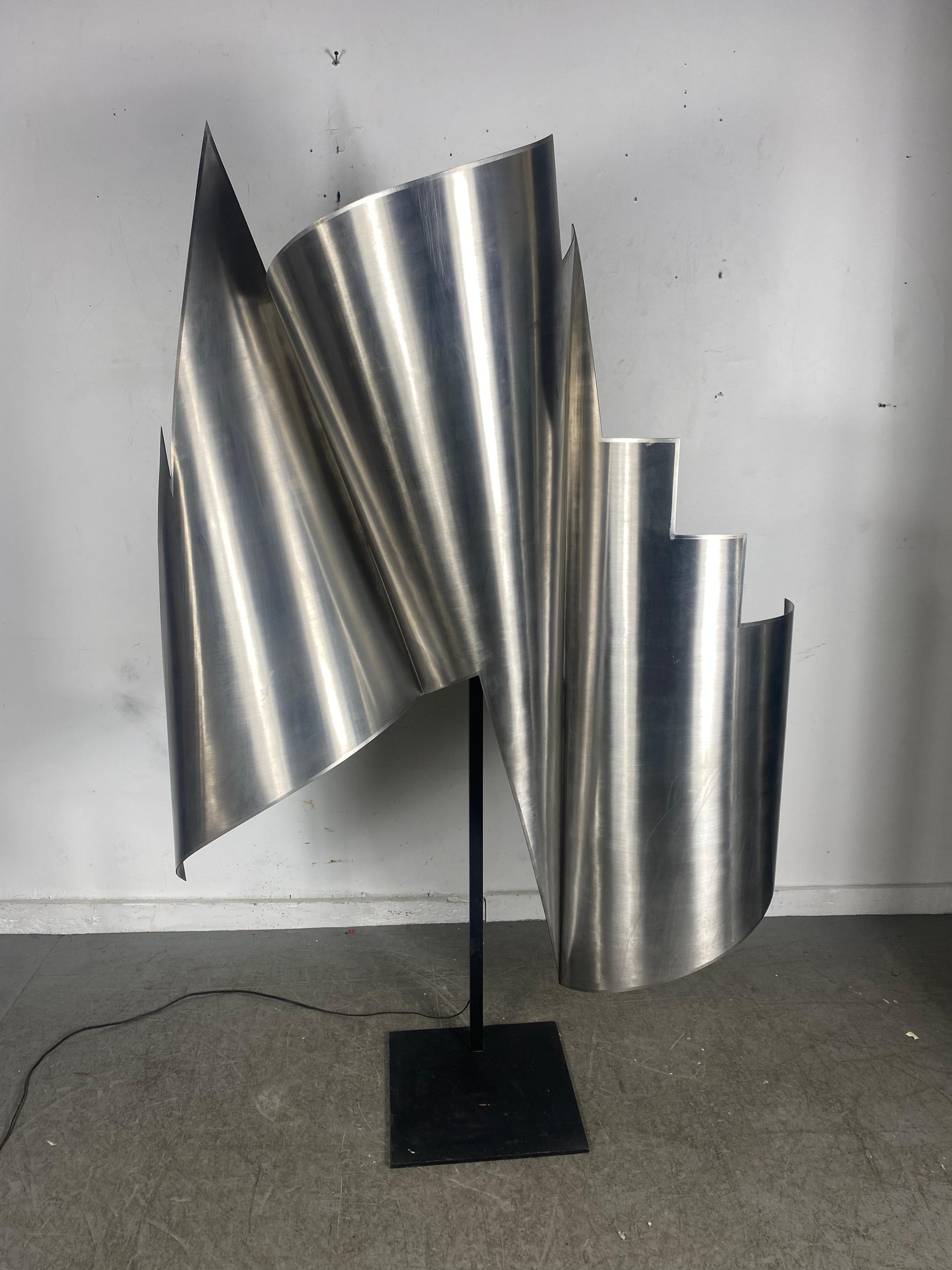  Monumental Modernist Abstract Rolled Stainless  Steel Sculpture / Lamp.. Illedgable signature ??  New York.. Amazing quality.. Extremely well executed.. Sculpture can be removed from stand and can be wall hung.. Hand delivery avail to New York City