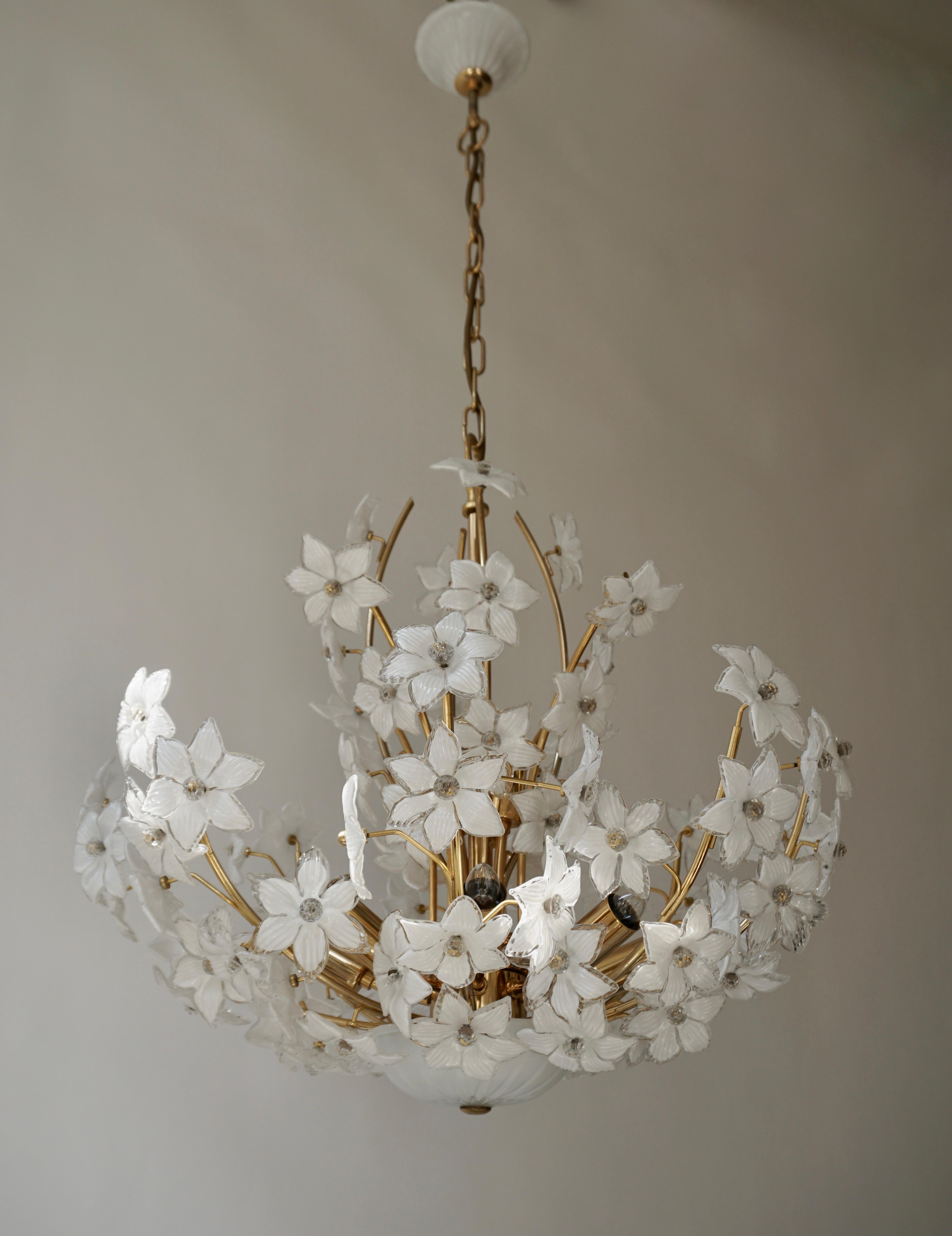 Large 1970s vintage midcentury Italian Murano flower bouquet Chandelier attributed to Venini. Art glass with 88 hand blown white and clear glass flowers and gold-plated brass. 
The glass flowers are attached with glass screws and the ceiling plate