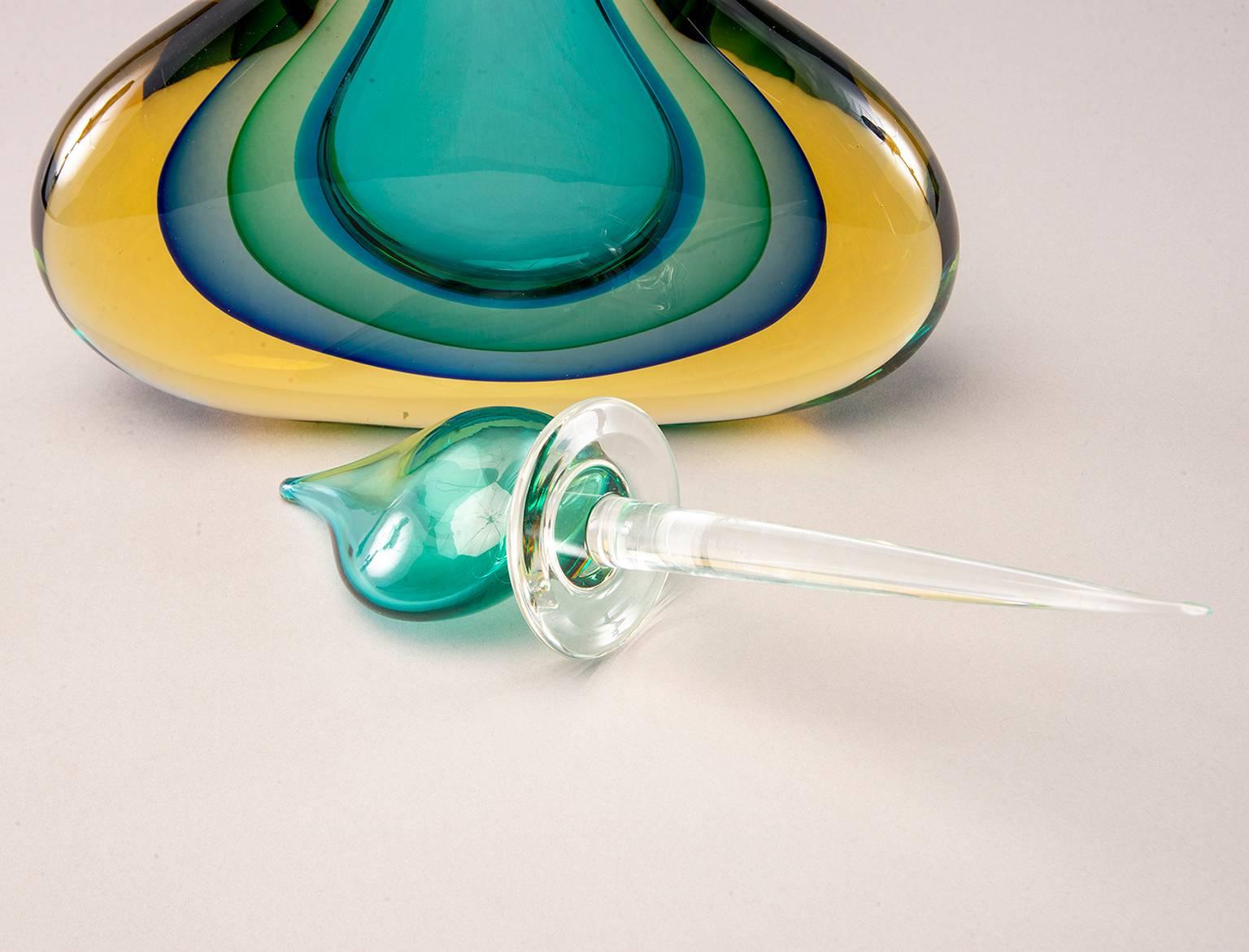 New monumental sommerso style Murano glass perfume bottle with glass stopper top in layered shades of amber, teal, blue, green and clear glass. Stunning, oversize statement piece. New with no flaws found. Unknown/unmarked Murano maker from our