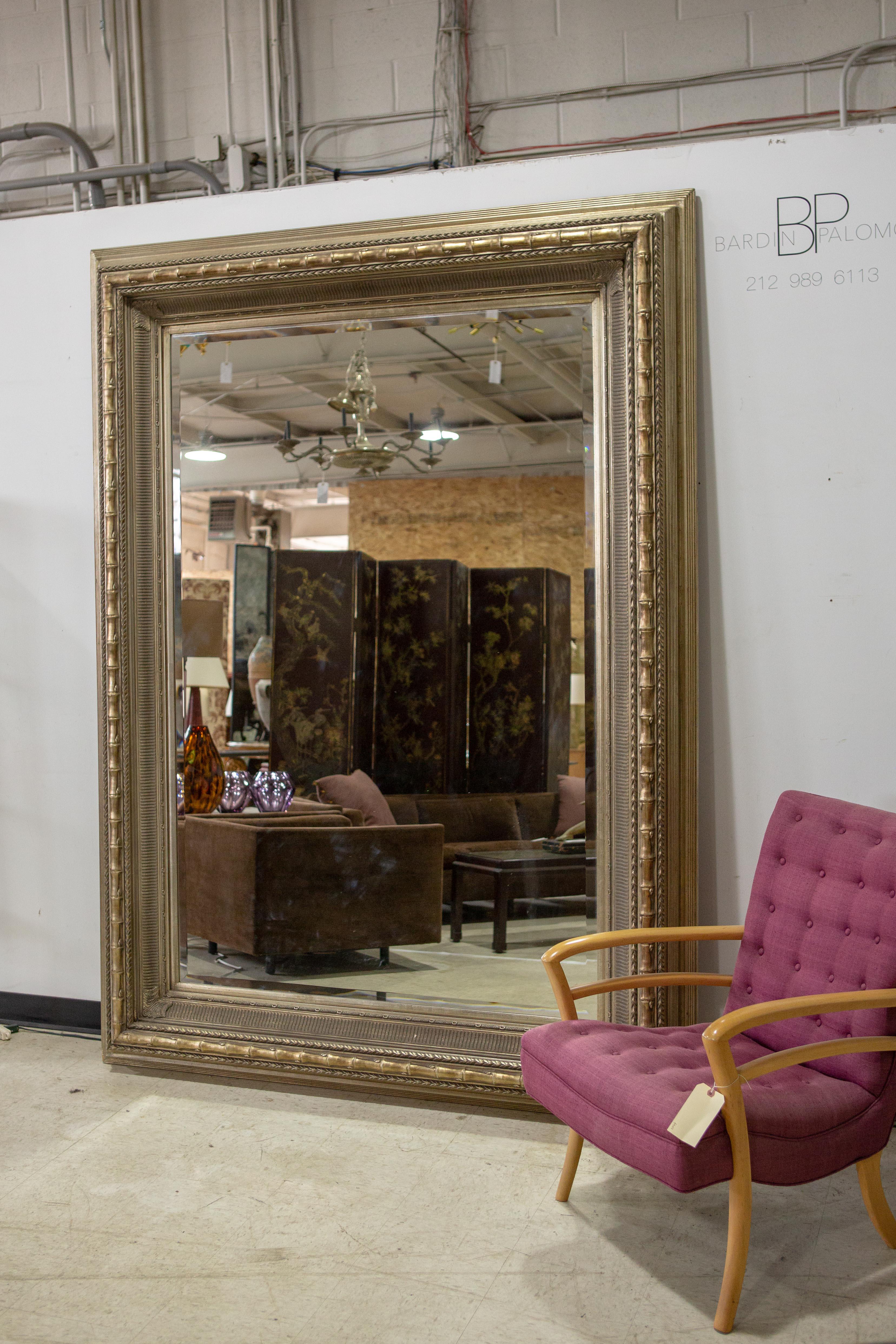 Monumental Neoclassical style metal mirror - Very large (over 7.5' H) , custom made, burnished metal leaf, Neoclassical style mirror with linear and bamboo details throughout. Mirror and frame are in amazing condition. Photo with chair for scale.