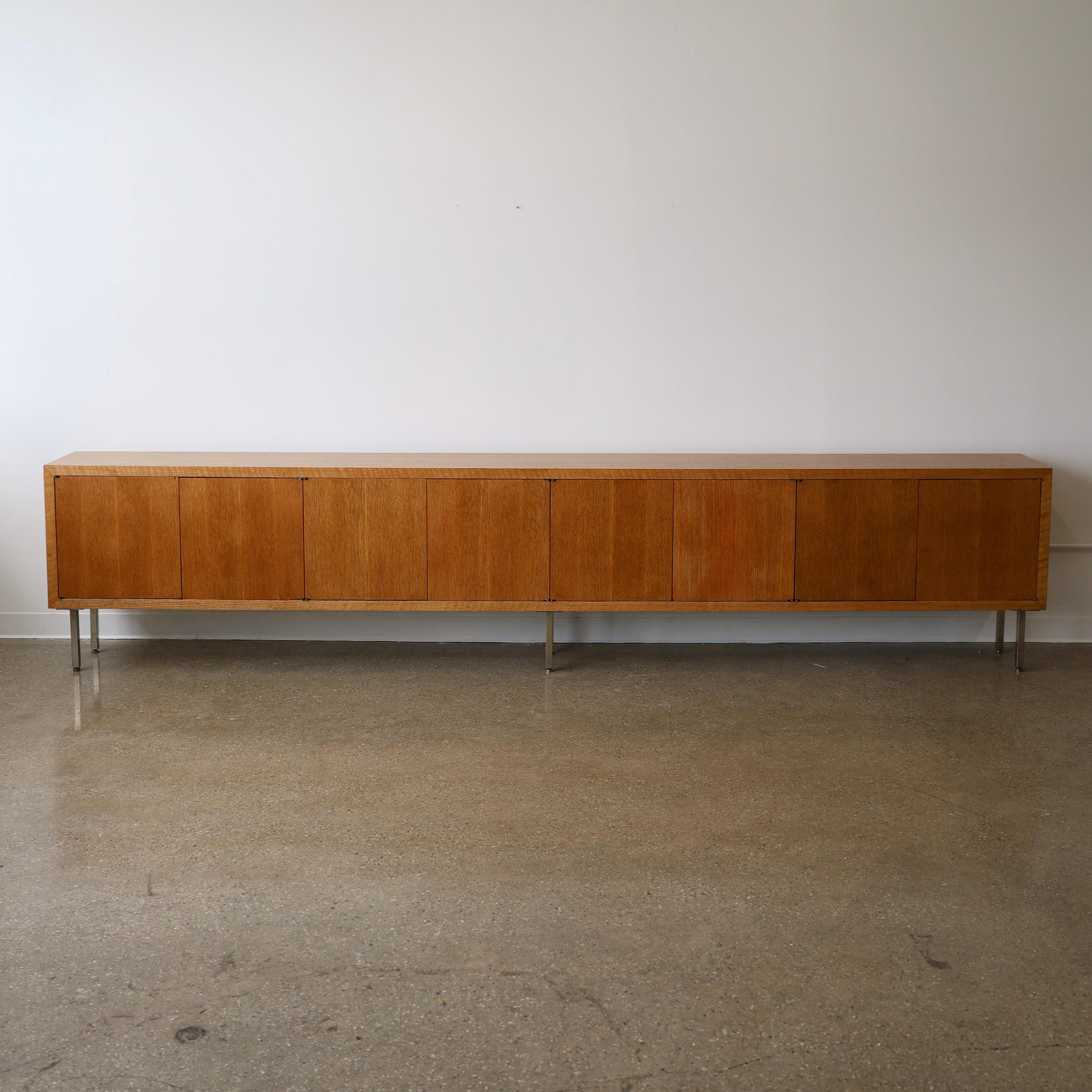 c. 1970s, fully restored and refinished. This piece features modular shelving, legs with levelers, and push-to-open doors. While it has been professionally restored, it still has some dings, chips, and wear from use and age. Please see photos for