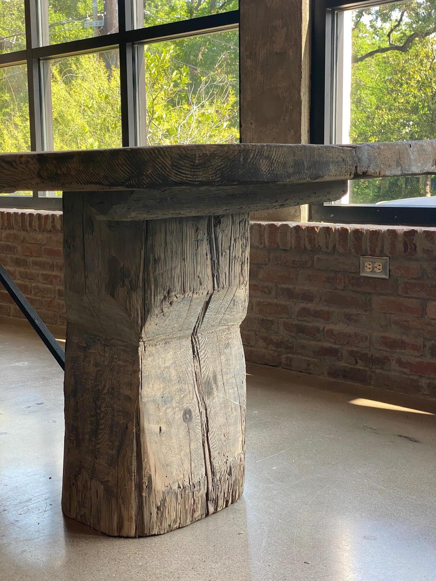 Monumental double pedestal dining table executed from 18th century hand hewn oak. Artisan made by French craftsmen, this table is epic in scale and rich with character. The table top is constructed with a trio of full length old growth European oak