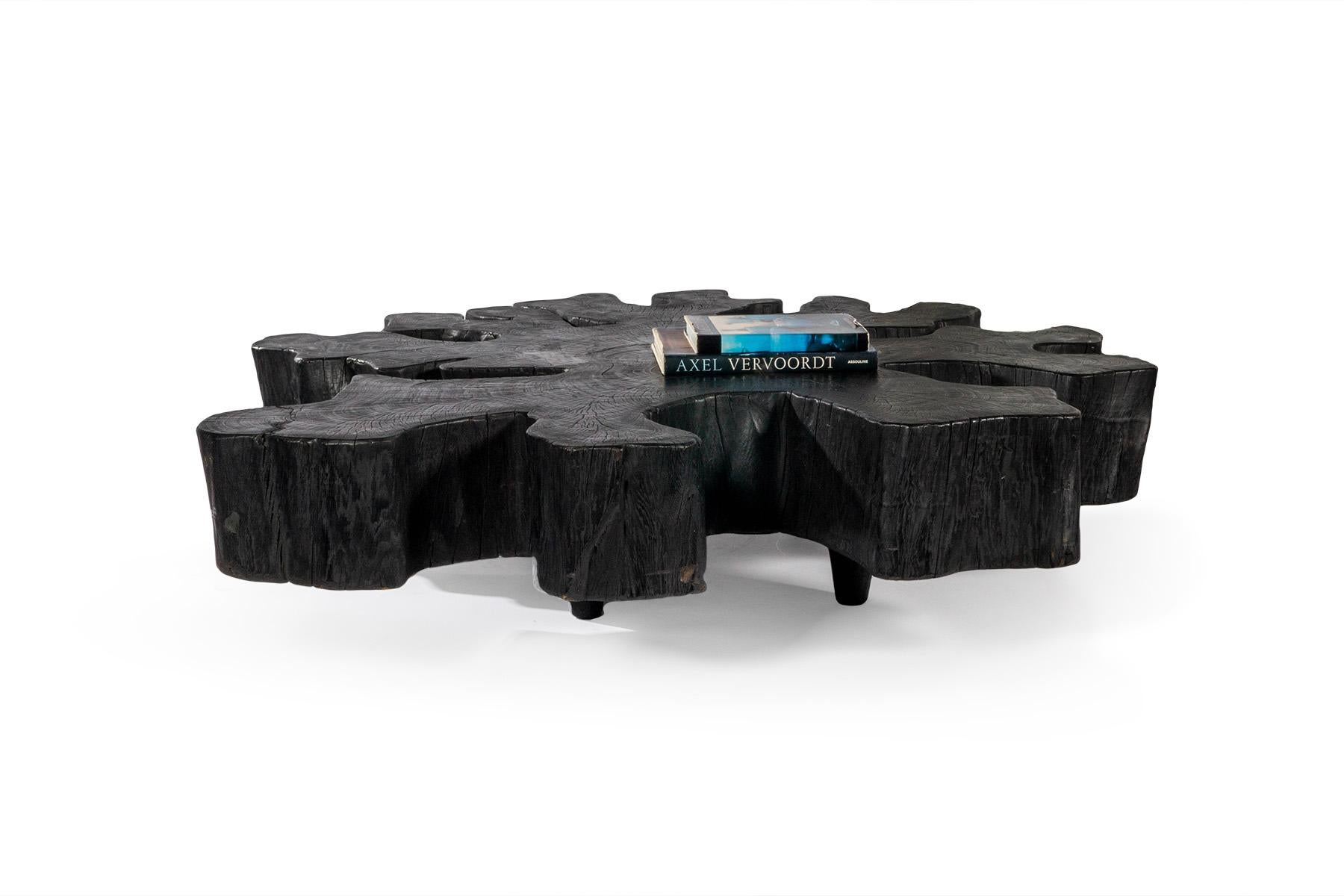 This organic form lychee wood coffee table features a beautiful ebony finish and dovetail inlay details. This piece is sure to be a statement piece in your home considering the bold contrast it provides and its monumental size. 

This piece is a