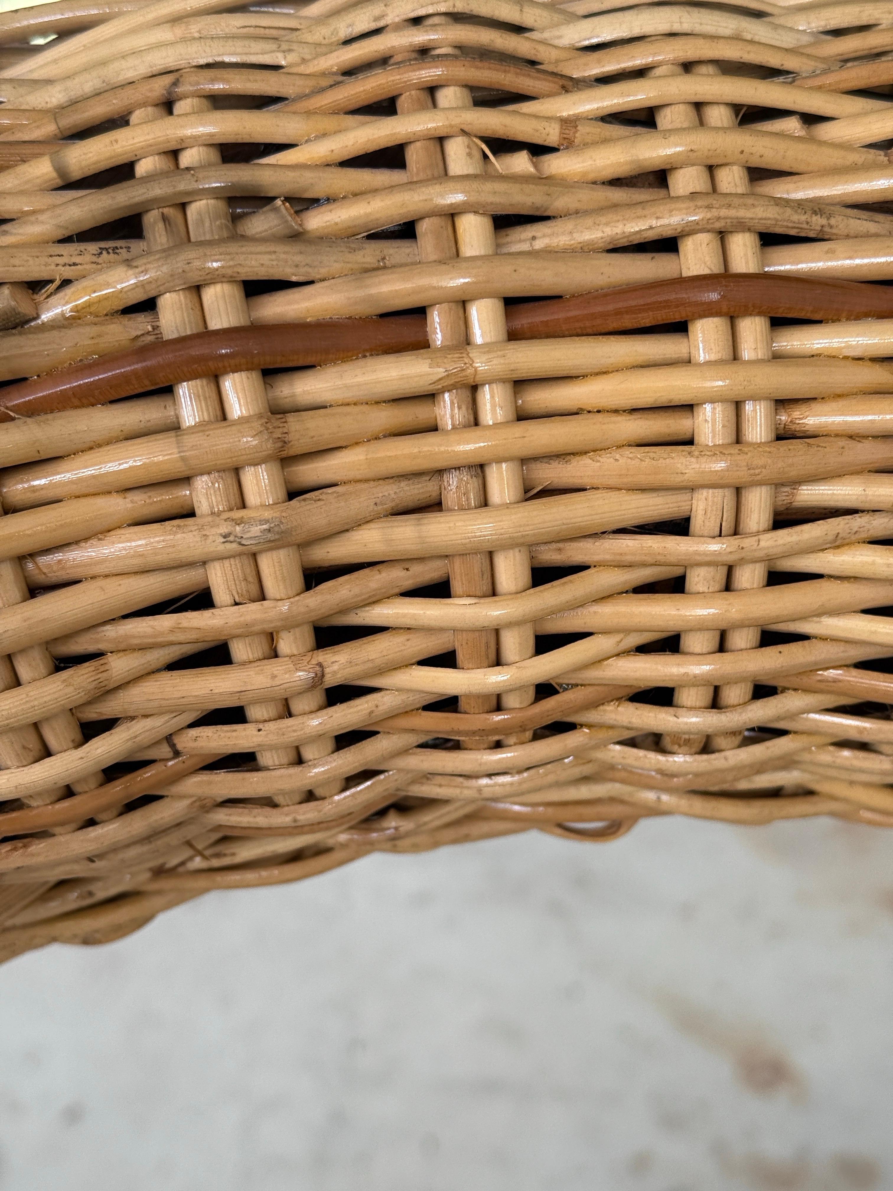 Make a statement with this stunning monumental rattan weave wall mirror by Wicker Works, dating from the 1990s. The intricately woven rattan frame showcases a bold, sculptural design, adding warmth and texture to any space. This substantial mirror