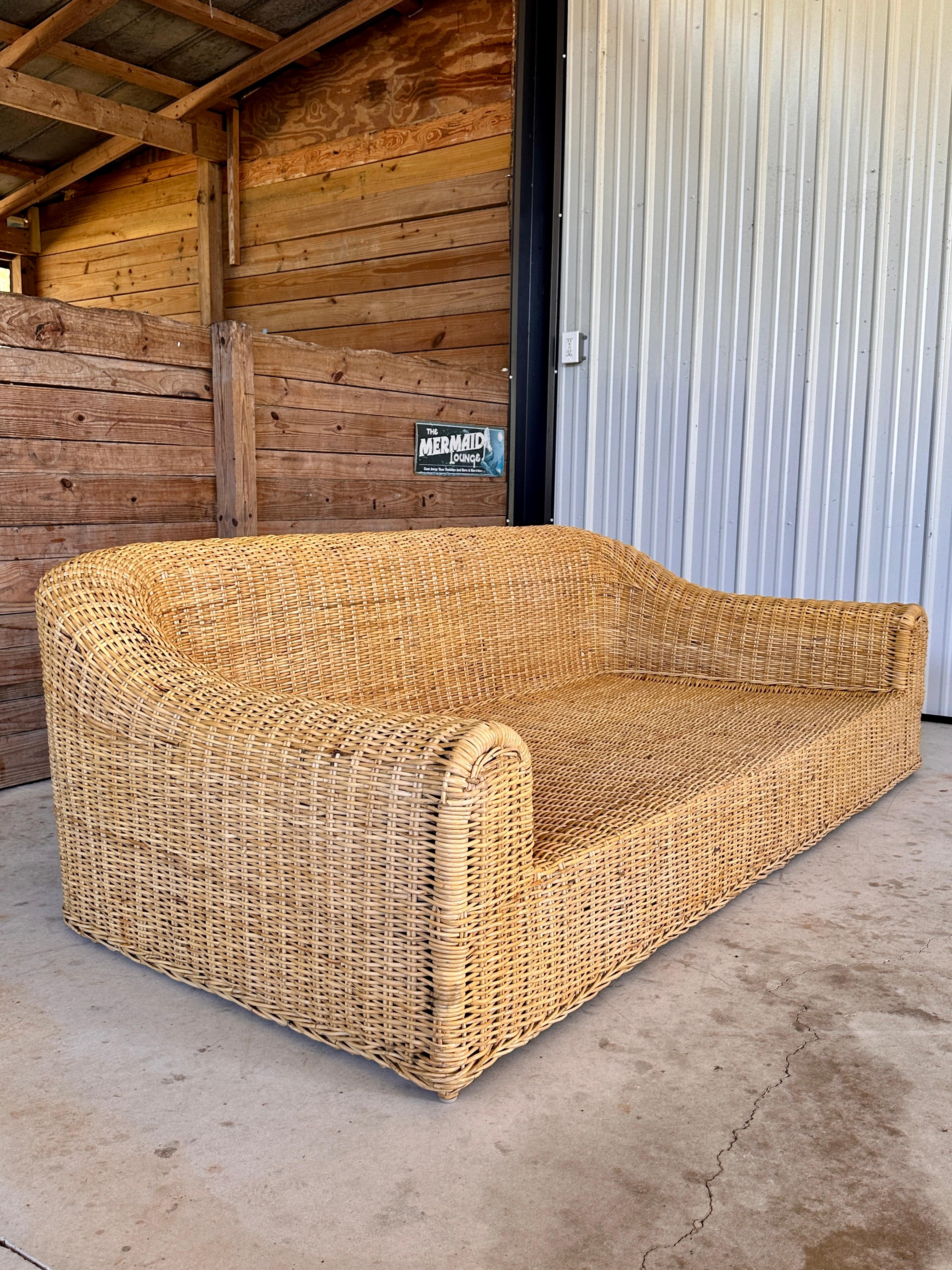 Vintage 1980s Rattan Braid Sofa by Michael Taylor, showcasing the designer’s iconic organic modern style. The sofa features a beautifully woven rattan braid frame with a soft, rounded silhouette that offers timeless appeal. The original fabric