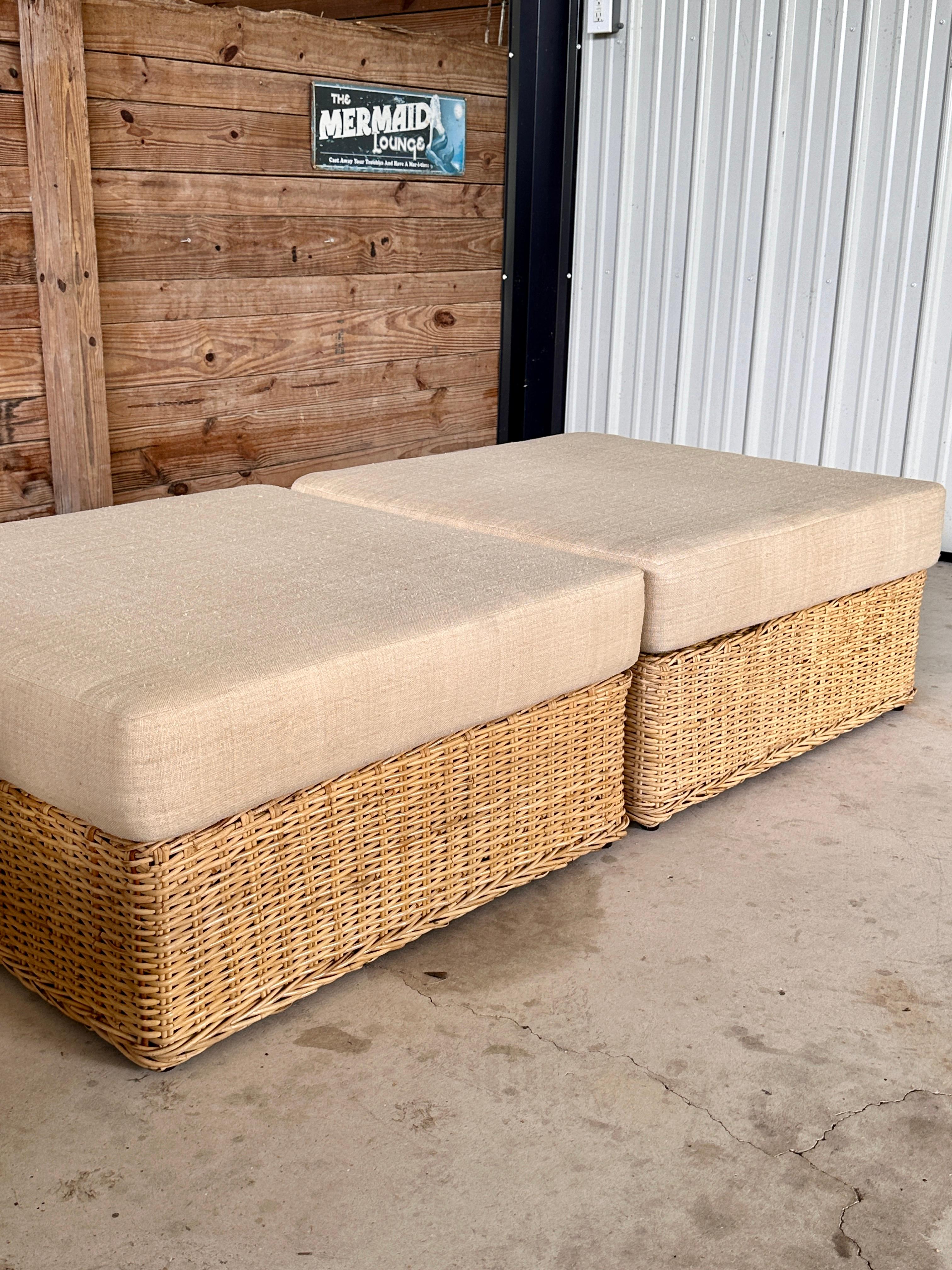 Crafted with an emphasis on scale and organic design, this pair of large rattan weave ottomans were custom made by Wicker Works.
Their expansive and low-profile form adds a statement of relaxed luxury to any living space. Each ottoman is topped with