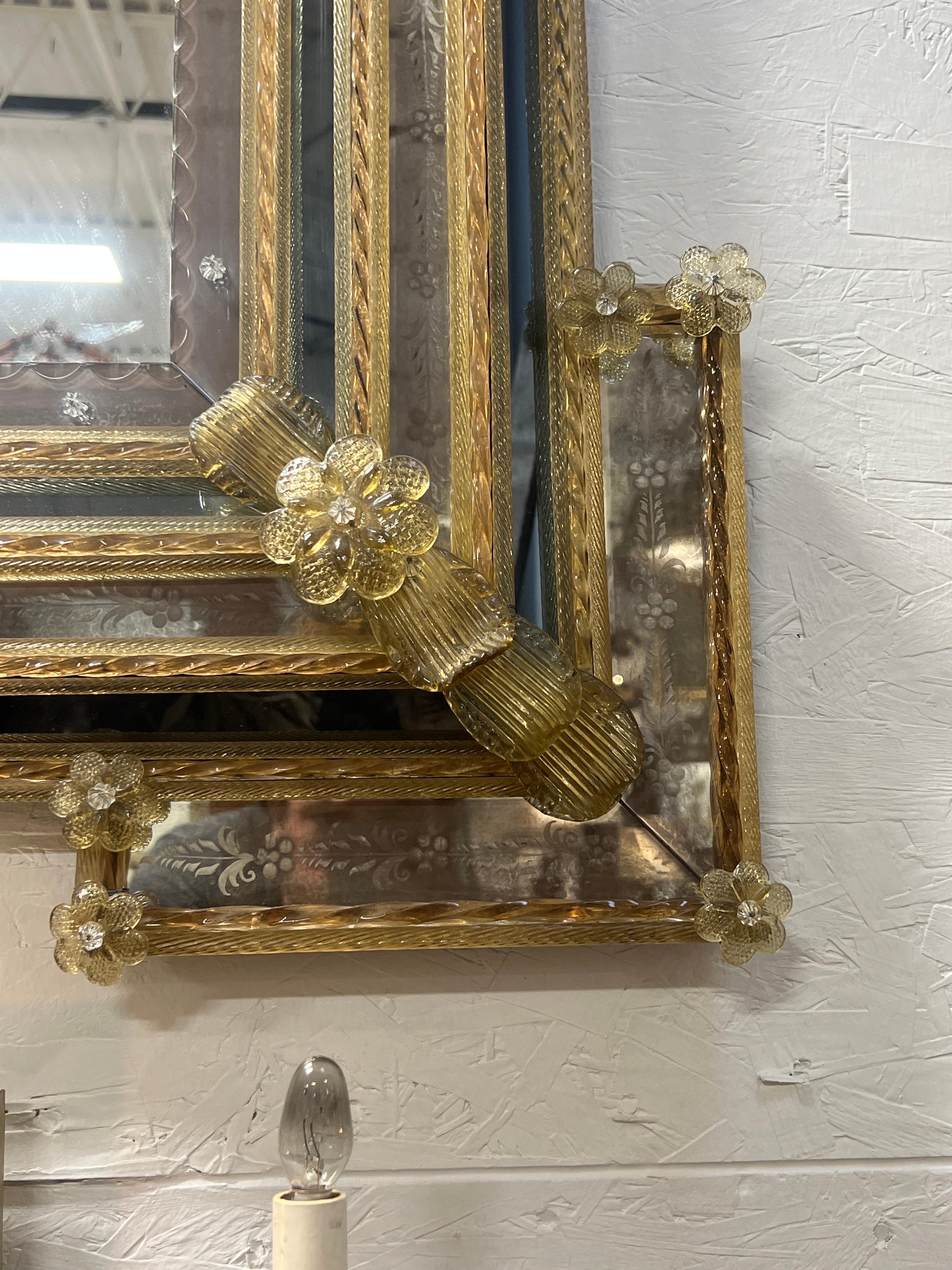 Venetian, Circa 1950.

An exceptionally large and fine quality mid century Venetian mirror of rectangular form, beveled glass edging, floral mounts, scrolled arms to top and etched glass across surfaces.