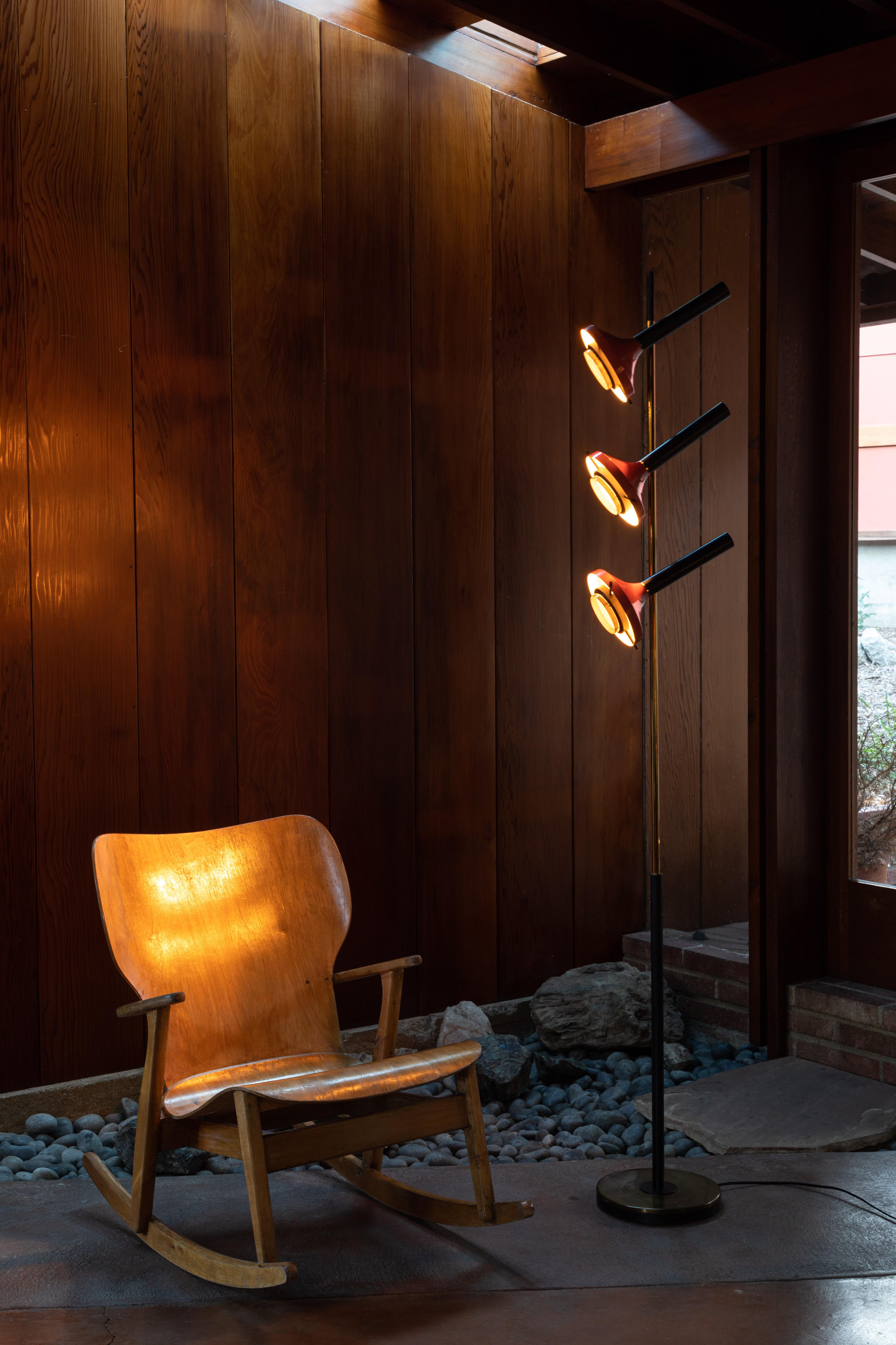 Monumental Oscar Torlasco 3-cone floor lamp for Lumi circa 1958. Iron base, tubular brass, sheet brass, part black, sheet aluminum, painted red, optical glass. Retains original manufacturers label. Each of the three shades have their own on/off