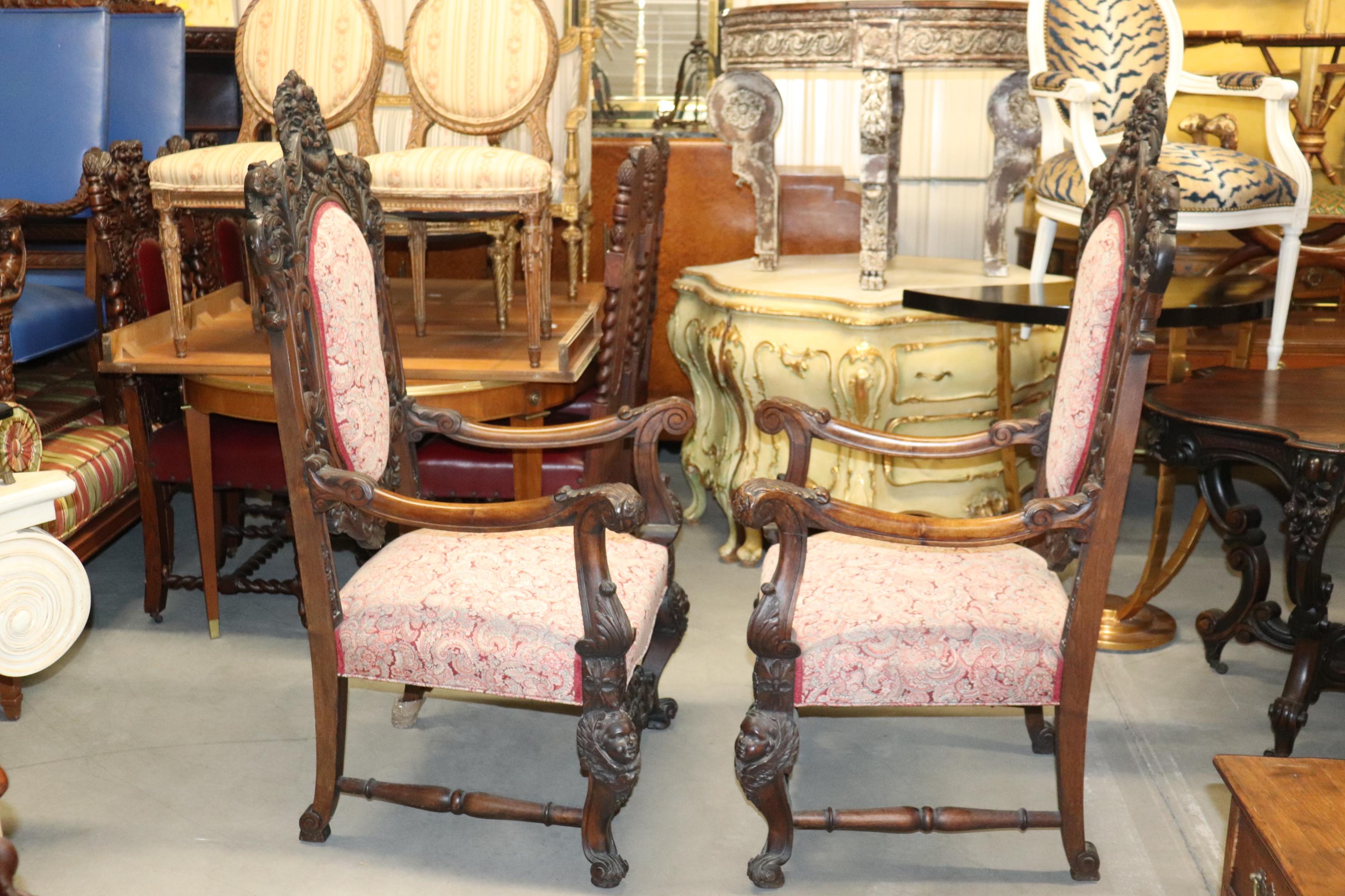 These chairs are crisply carved walnut and generously proportioned for larger people or just anyone who wants to be a king or queen in their castle. The chairs are upholstered in fashionable paisley and in very good condition. The chairs measure 57