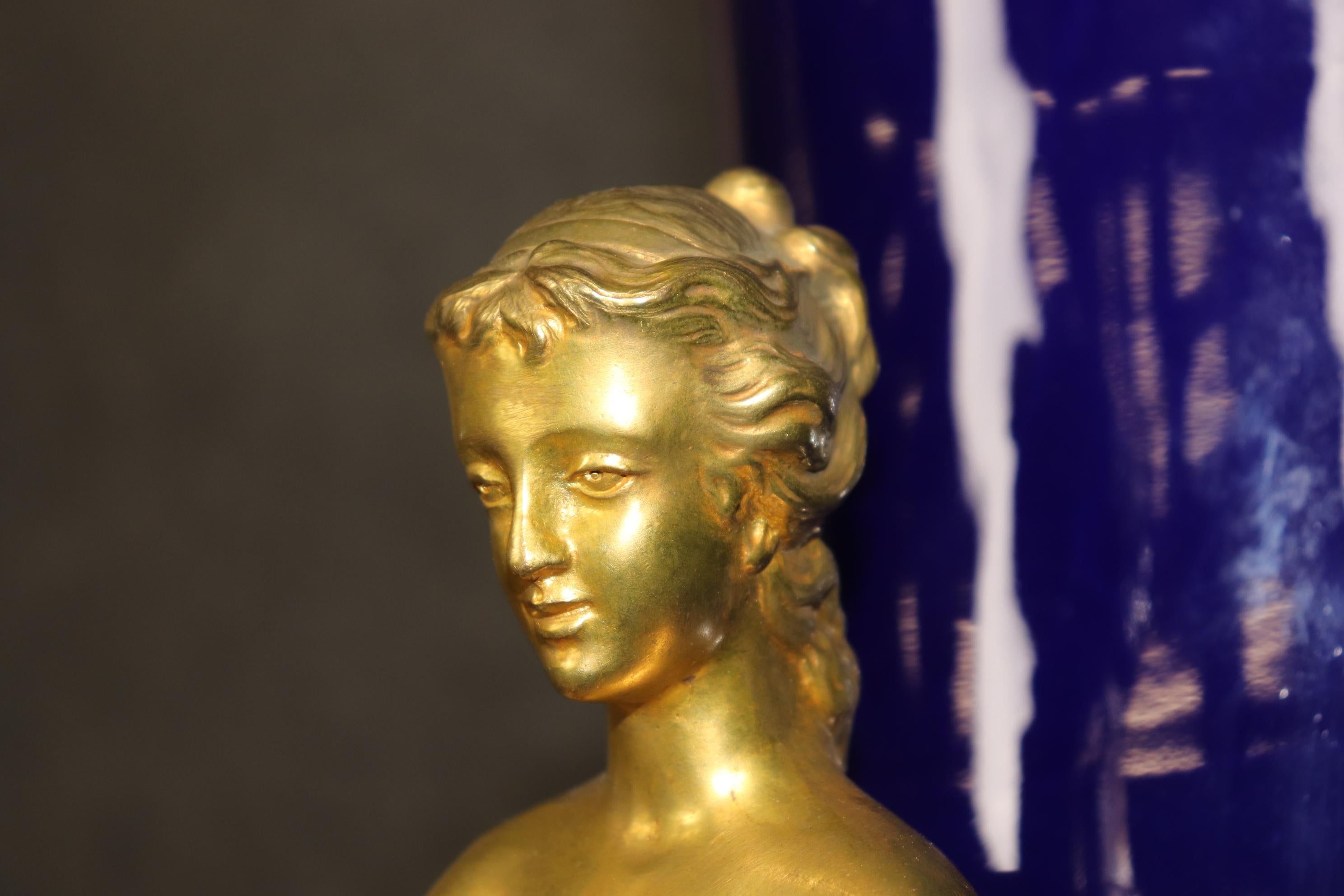 Dies ist ein auffälliges Paar monumentaler, in Bronze gefasster Porzellanurnen mit herrlichen Details in Bezug auf die Gestaltung der Gesichter und Blumengirlanden. Die Bronze ist ganz Dore' Gold beendet und in sehr gutem Zustand mit minimalen, wenn