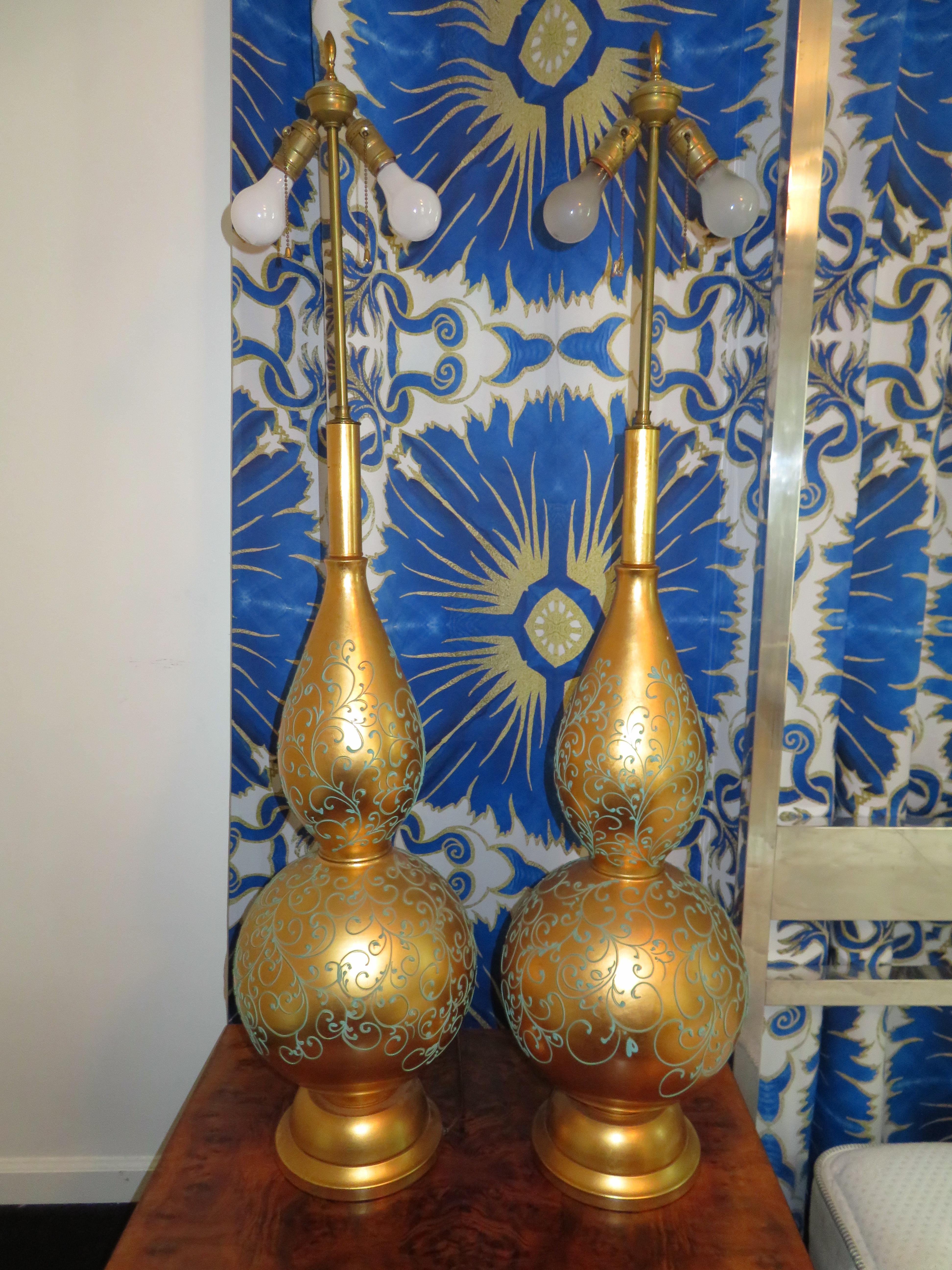 Monumental and magnificent pair of gold leaf gourd shaped lamps with their original golden shades. There are no words to describe how absolutely fabulous these lamps truly are. They are a whopping 52