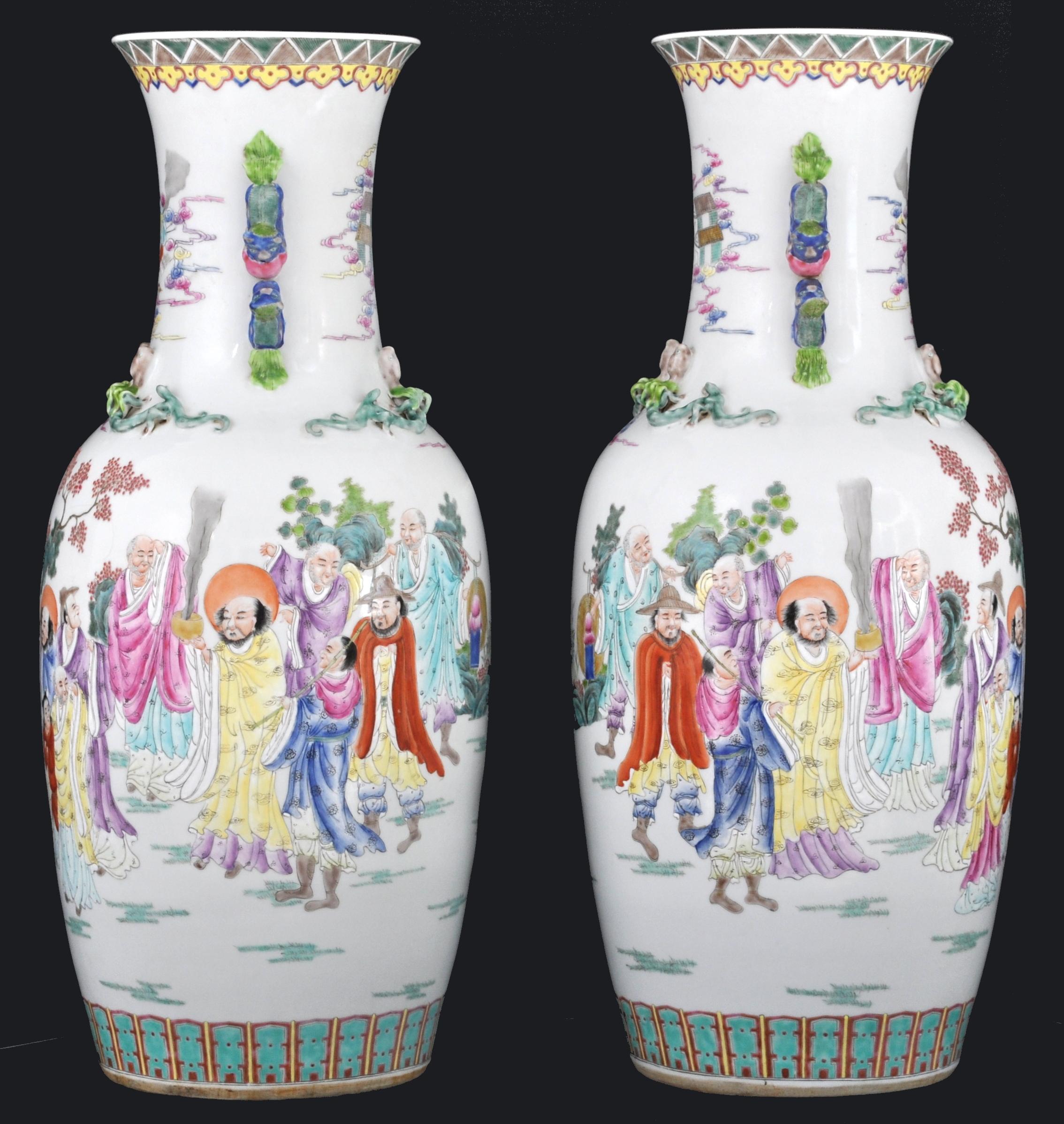 Monumental pair of antique Chinese late Qing to early Republican period Famille Rose Porcelain vases. The vases of baluster form with applied handles modeled as dragons, each vase with a hand painted polychrome scene of immortal figures in a garden