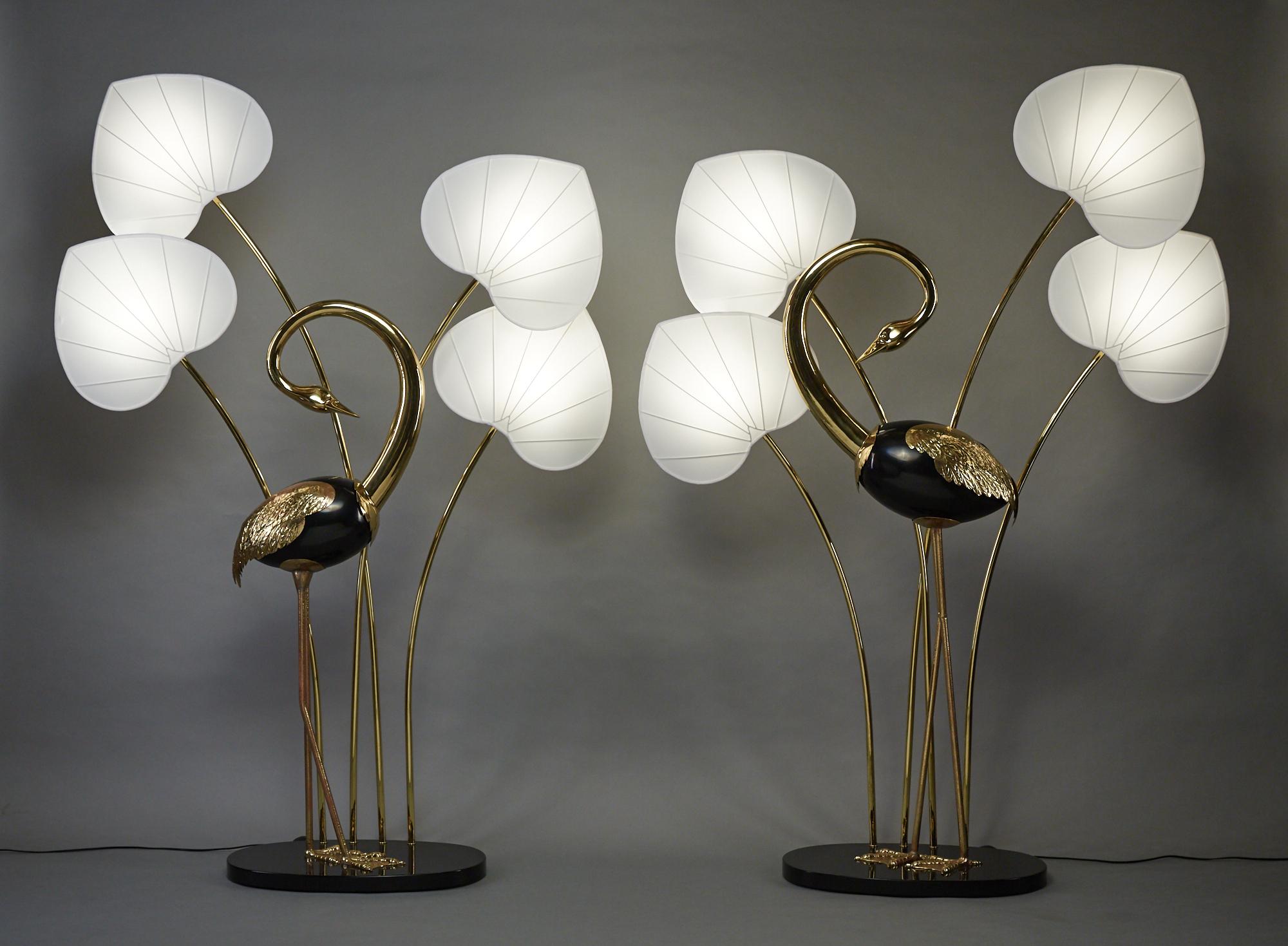 Monumental pair of brass standing egret / flamingo floor lamps by Antonio Pavia with black lacquered wood body.
Lamps measure 80 inches high including the shades. One egret by itself measures 55 inches tall and the other 61 inches. Lamps have on/off