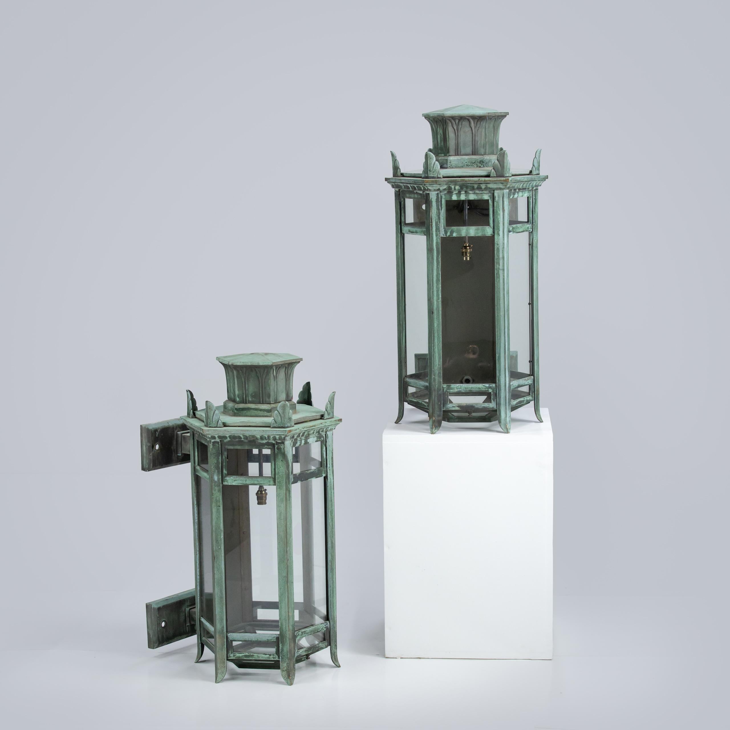 Truly magnificent pair of bronze wall hung porch lanterns, simply vast scale, excellent natural verdigris patination. Fine crisp casting. Beautifully manufactured. 

England, Early 20th Century.