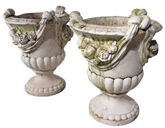 Monumental Pair of Cast Stone Urn Form Planters with Flower and Swag Decoration