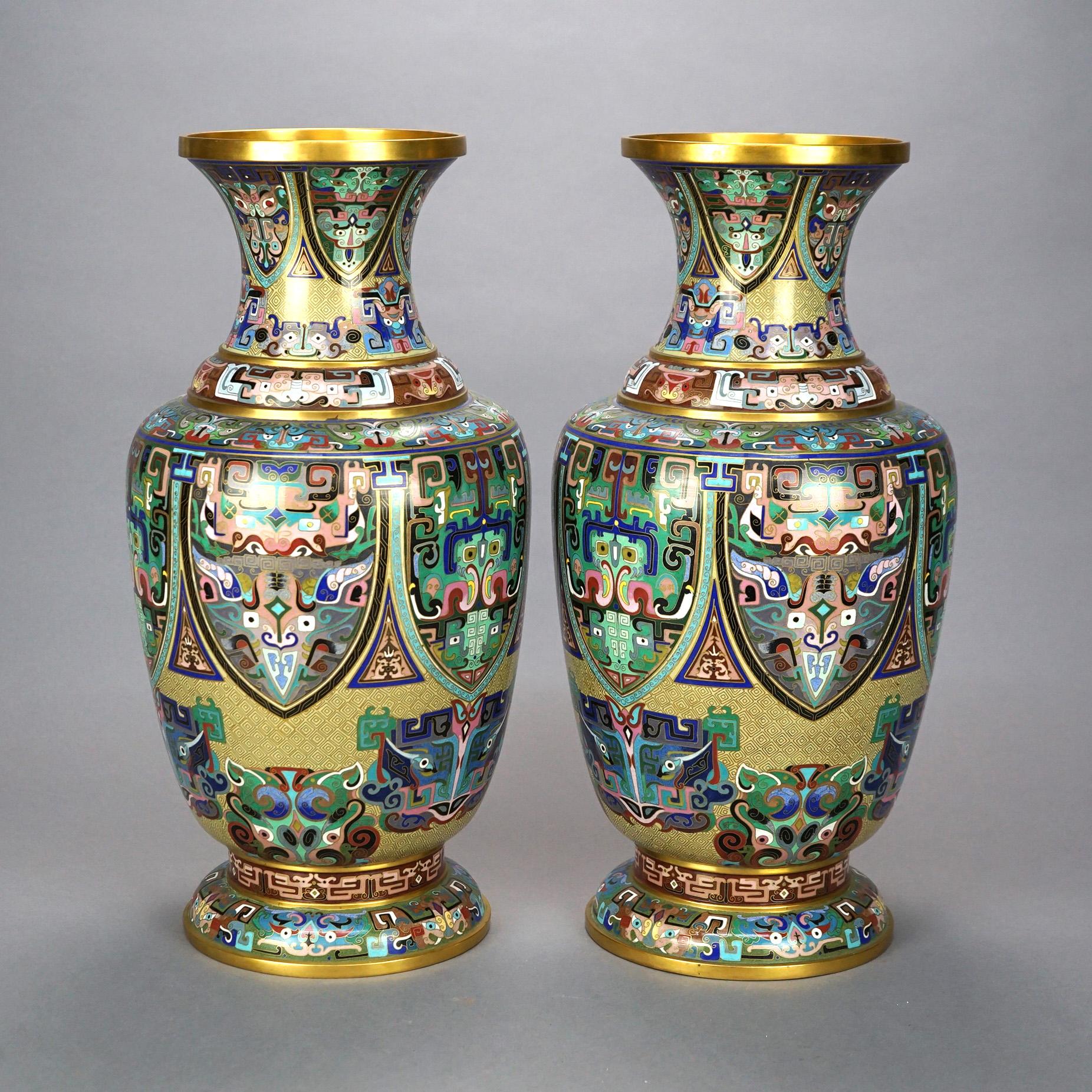 A pair of large Chinese vases offer metal construction decorated with cloisonne enamel design with included stylized foliate and animal elements, 20th century

Measures- 20.5''H x 10''W x 10''D.