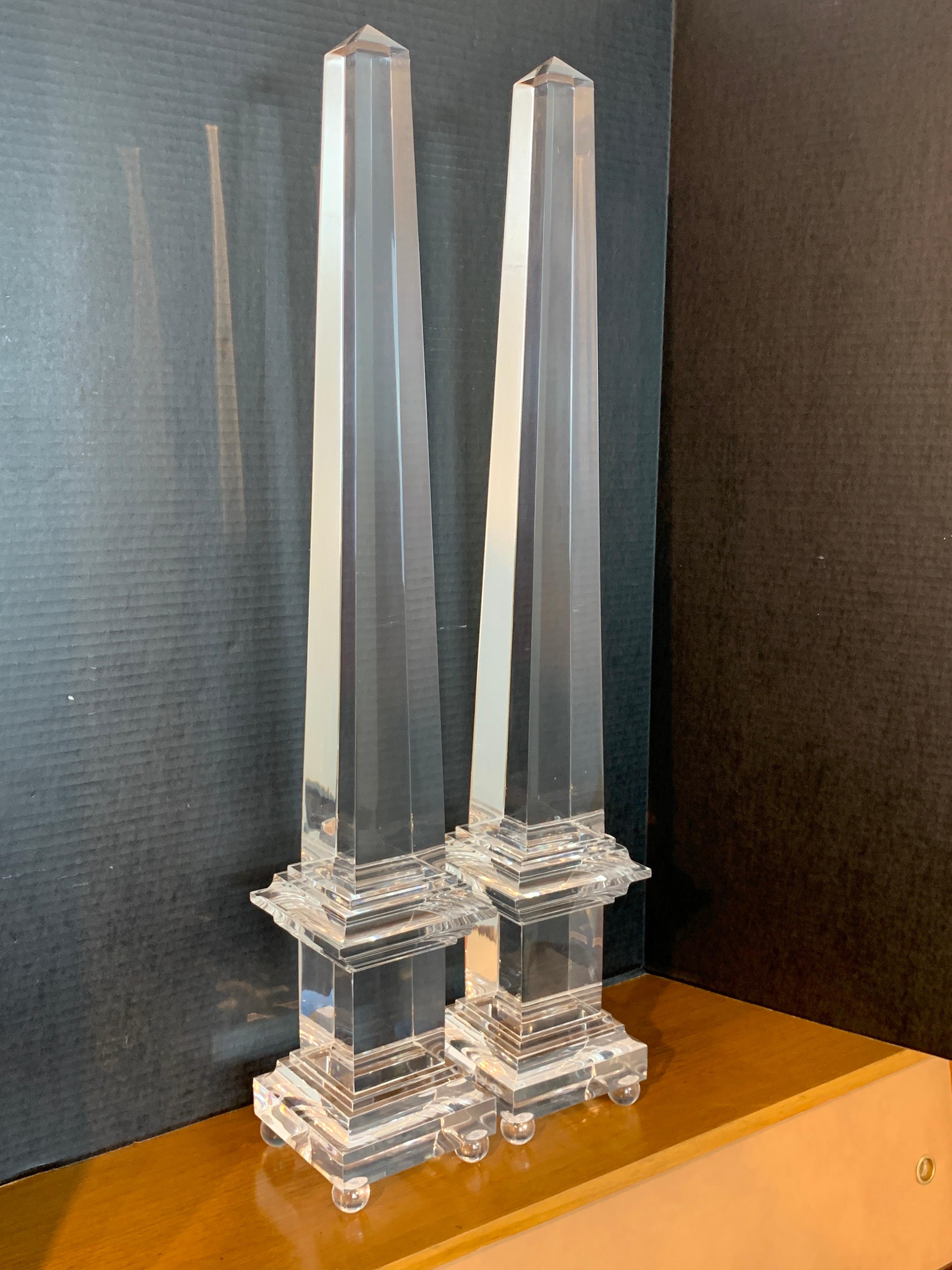 A monumental pair of footed Lucite obelisks, each one of typical form, tall, sleek and clear, a rare size.