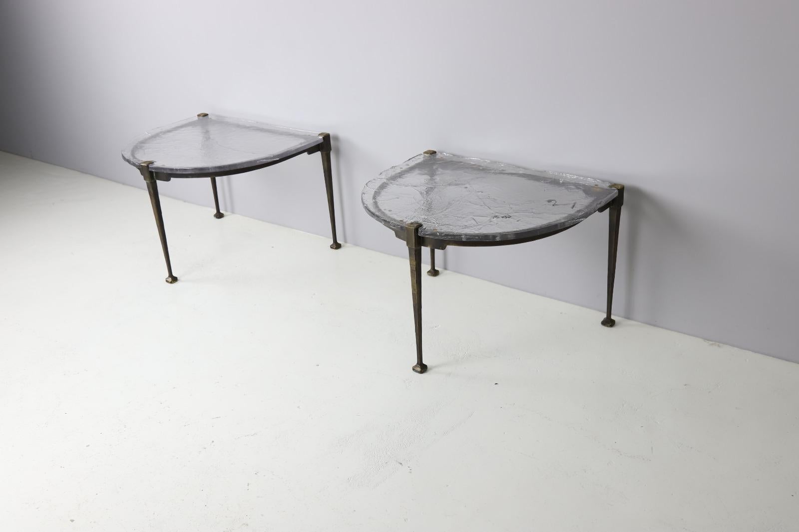 Monumental pair of side tables by Lothar Klute. Heavy forged bronze frames with a thick hand blown glass on top. Signed on the base and in the glass.
Very good original condition. Over the year the bronze has obtained a beautiful warm patina.