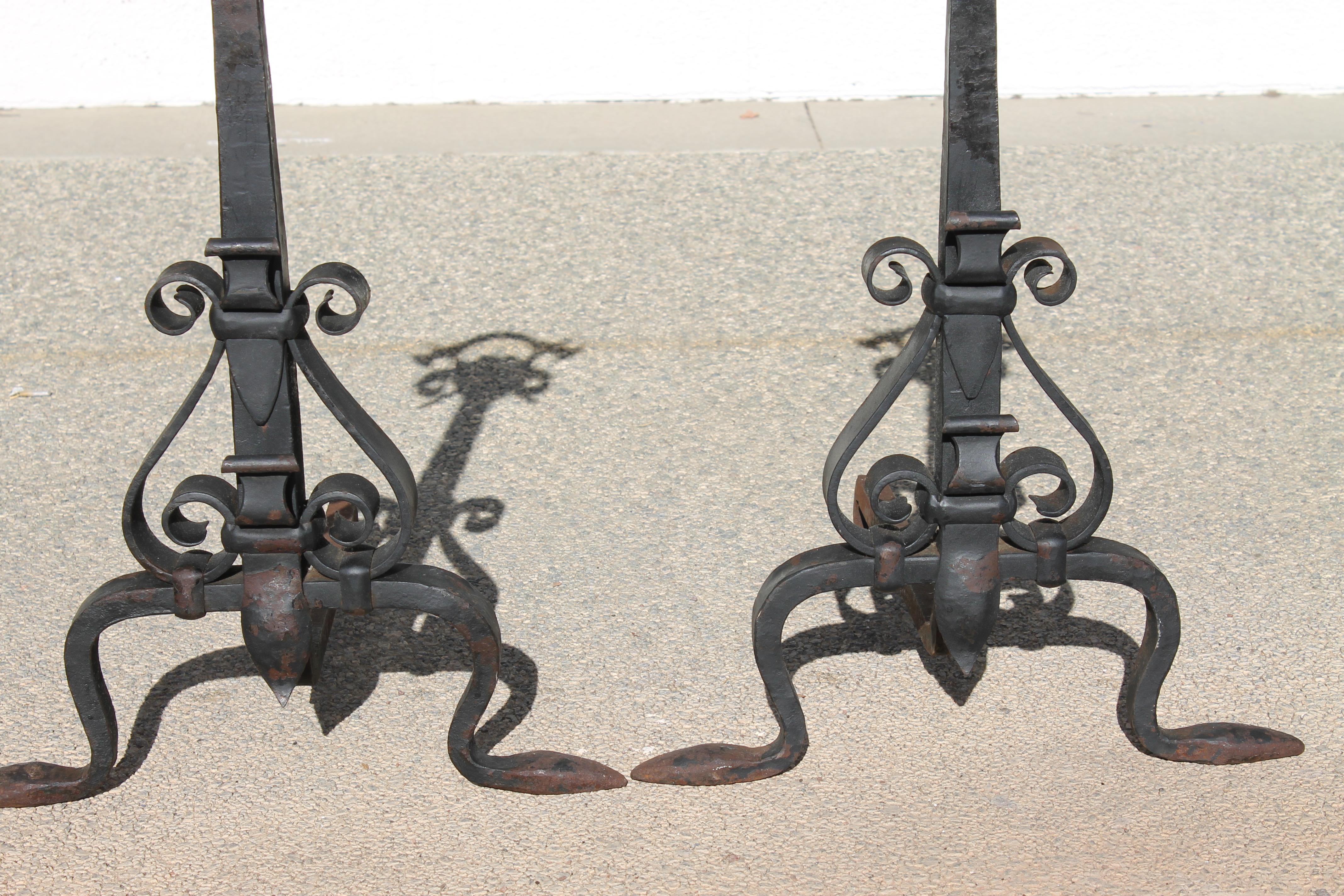 Hand forged heavy gauge andirons with iron strapping and heraldic shields and battle axes. Generously sized at 18.5