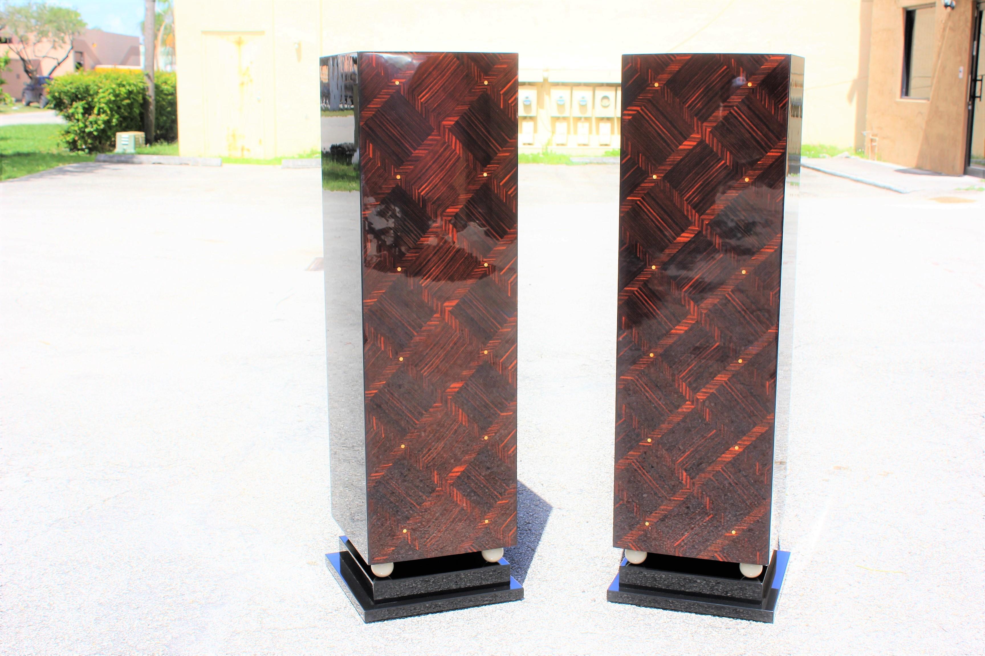 Beautiful pair of French exotic Macassar ebony mother-of-pearl accents pedestals, circa 1940s. Square geometric bases with wood four balls ivory finish. These pedestals are Macassar ebony and black lacquer, with mother-of-pearl accents, high-gloss