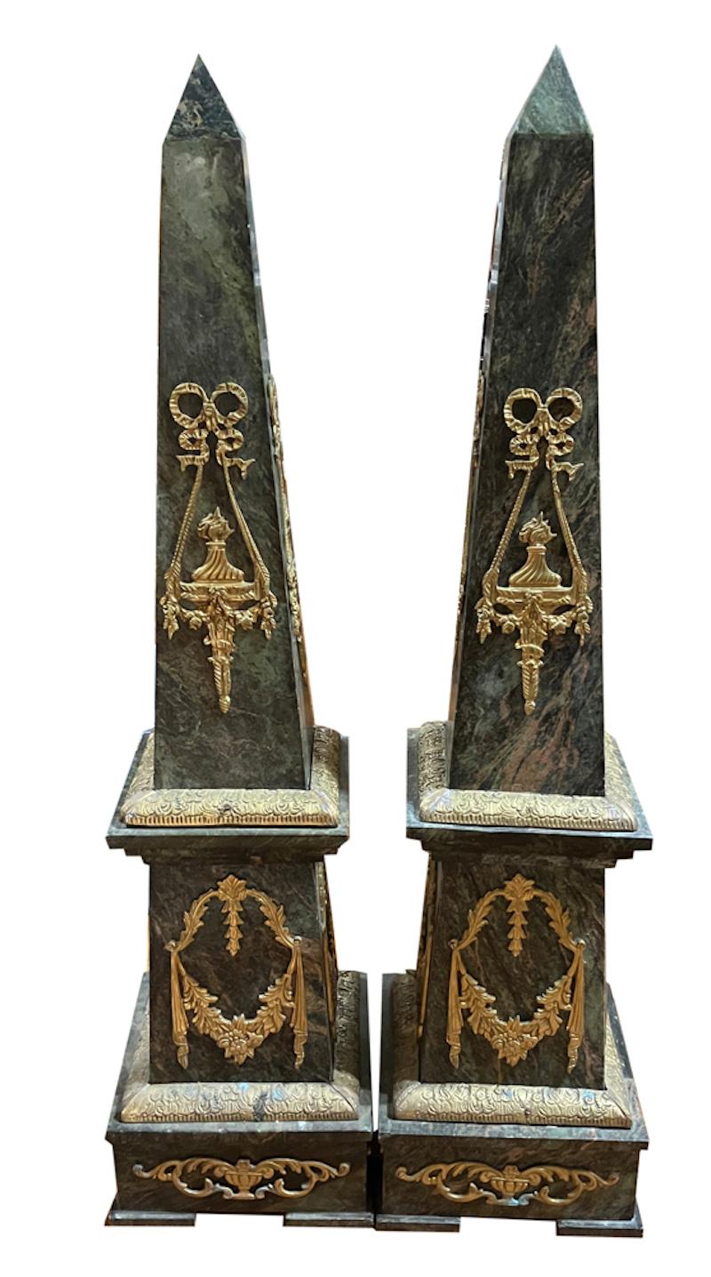 This finely detailed set of Empire obelisks has drama and impact. Done as a pair of green marble shafts set upon plinths then set upon marble bases with bronze trim. Most likely created in France in the 1800