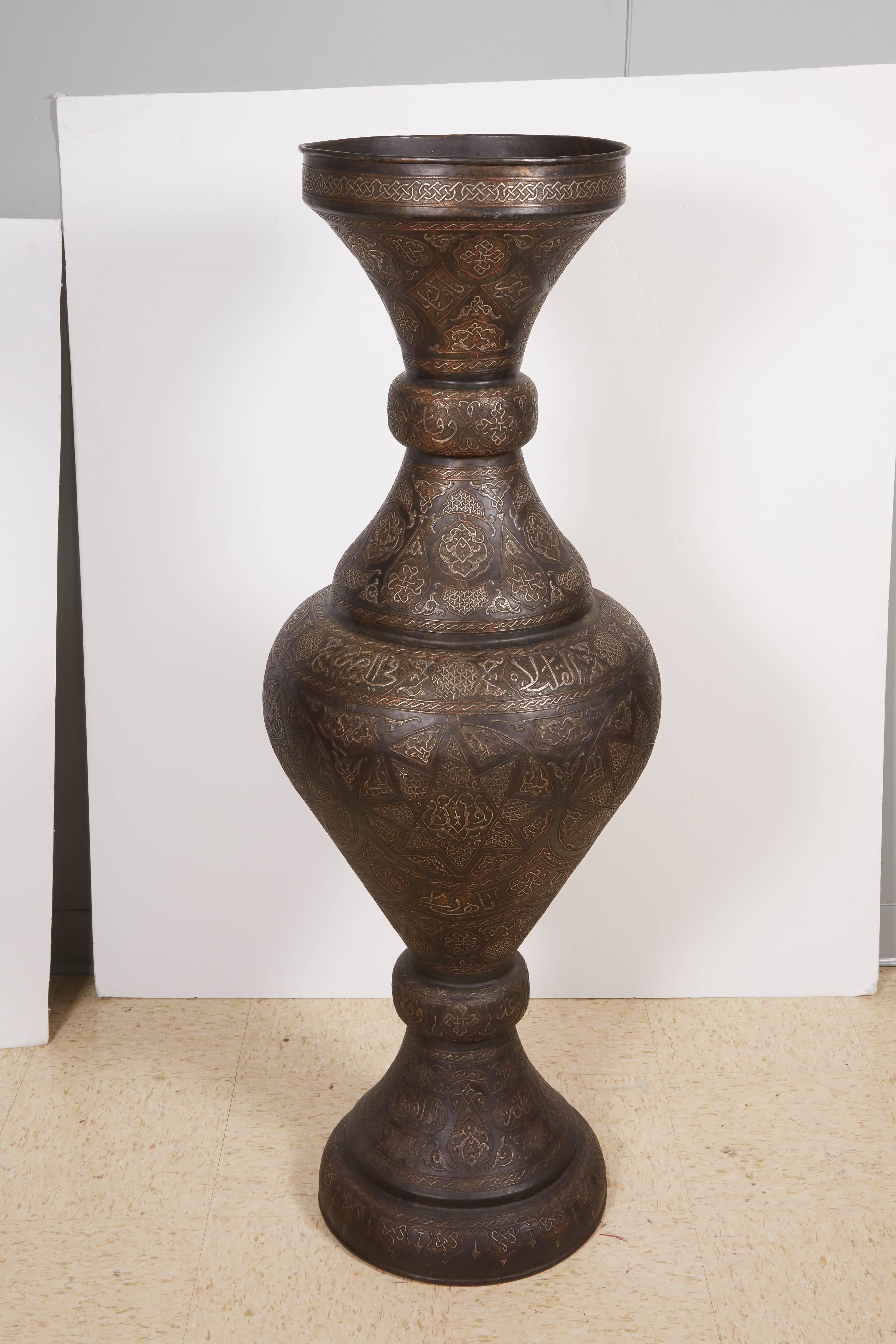 Monumental pair of Islamic silver inlaid bronze palace vases with Arabic calligraphy throughout,
 
High quality vases, very good design. Will go very well in an Islamic / Moroccan room.

Very good condition, Ready to place.

Measure: 52