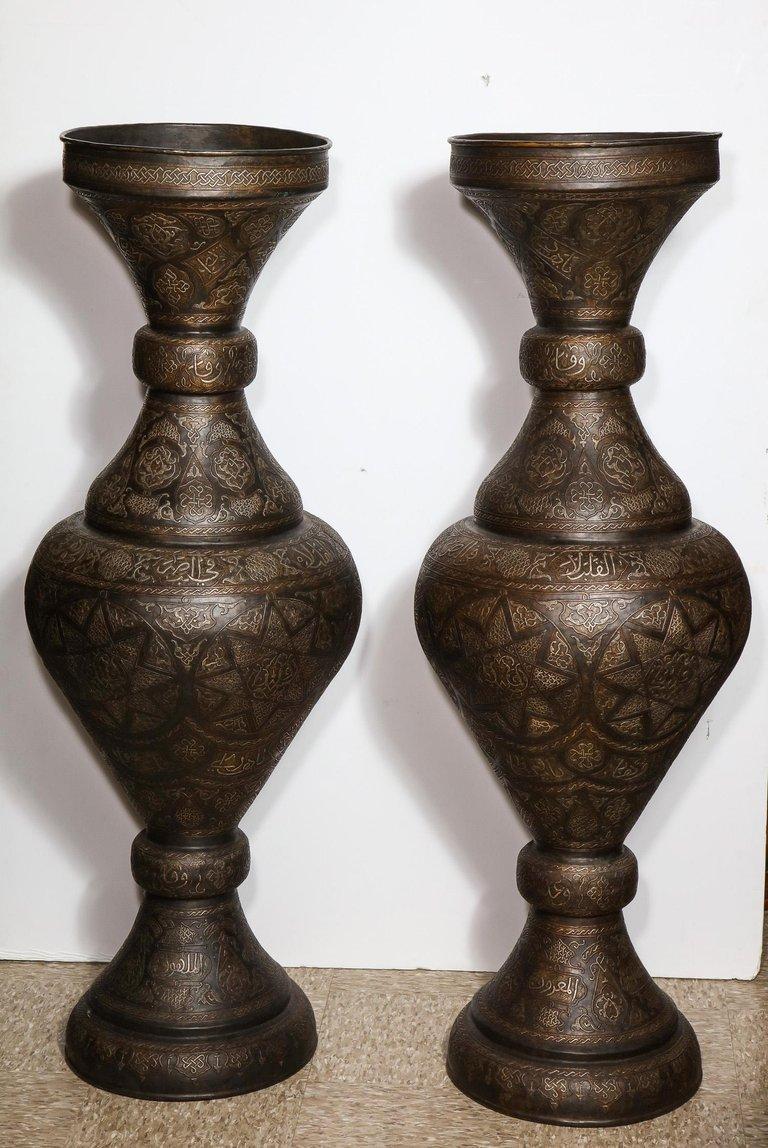 Monumental pair of Islamic silver inlaid bronze palace vases with Arabic calligraphy throughout. 

High quality vases, very good design. Will go very well in an Islamic or Moroccan room.

Very good condition, ready to place.

Measure: 52? high