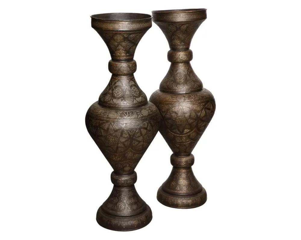 Monumental pair of Islamic silver inlaid bronze palace vases with Arabic calligraphy throughout.

High quality vases, very good design. Will go very well in an Islamic or Moroccan room.

Very good condition, ready to place.

Measure: 52? high