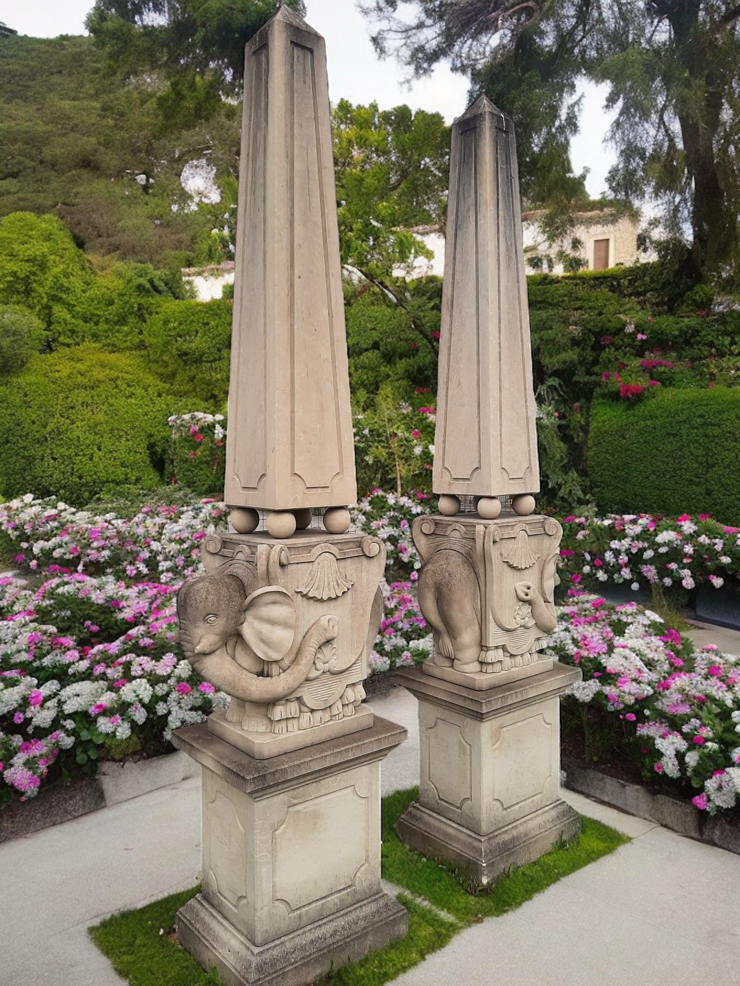 Pair of finely carved elegant stone obelisks decorated with leave garlands, on a square base.
 Inspired by Bernini's  elephant in Piazza della Minerva Rome.
Timeless decoration for your garden or interior.
Measurements, Obelisks - Height cm