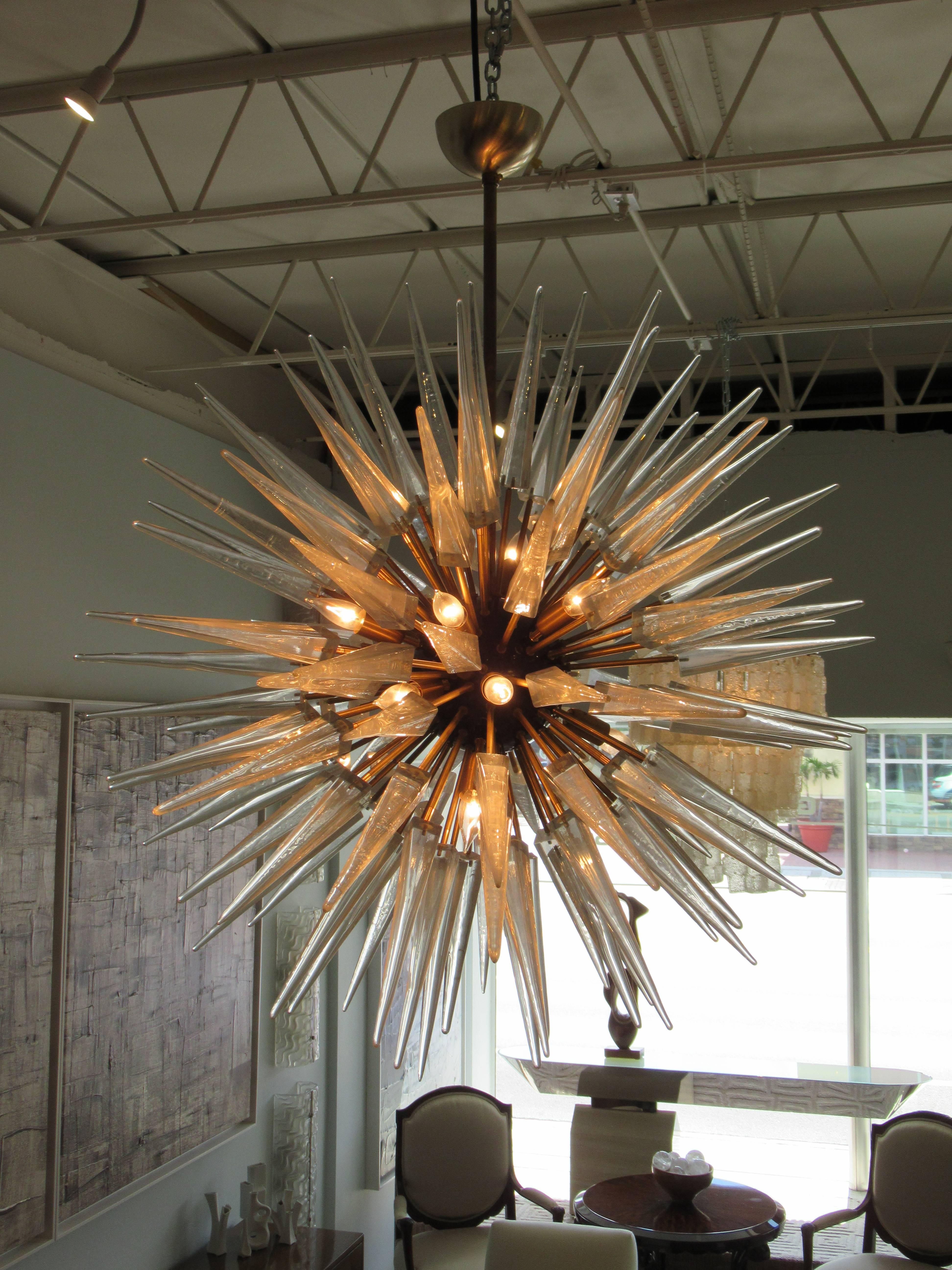 Monumental Italian modern brass, enameled, and hand blown glass sputnik chandelier, the triangular handblown glass 