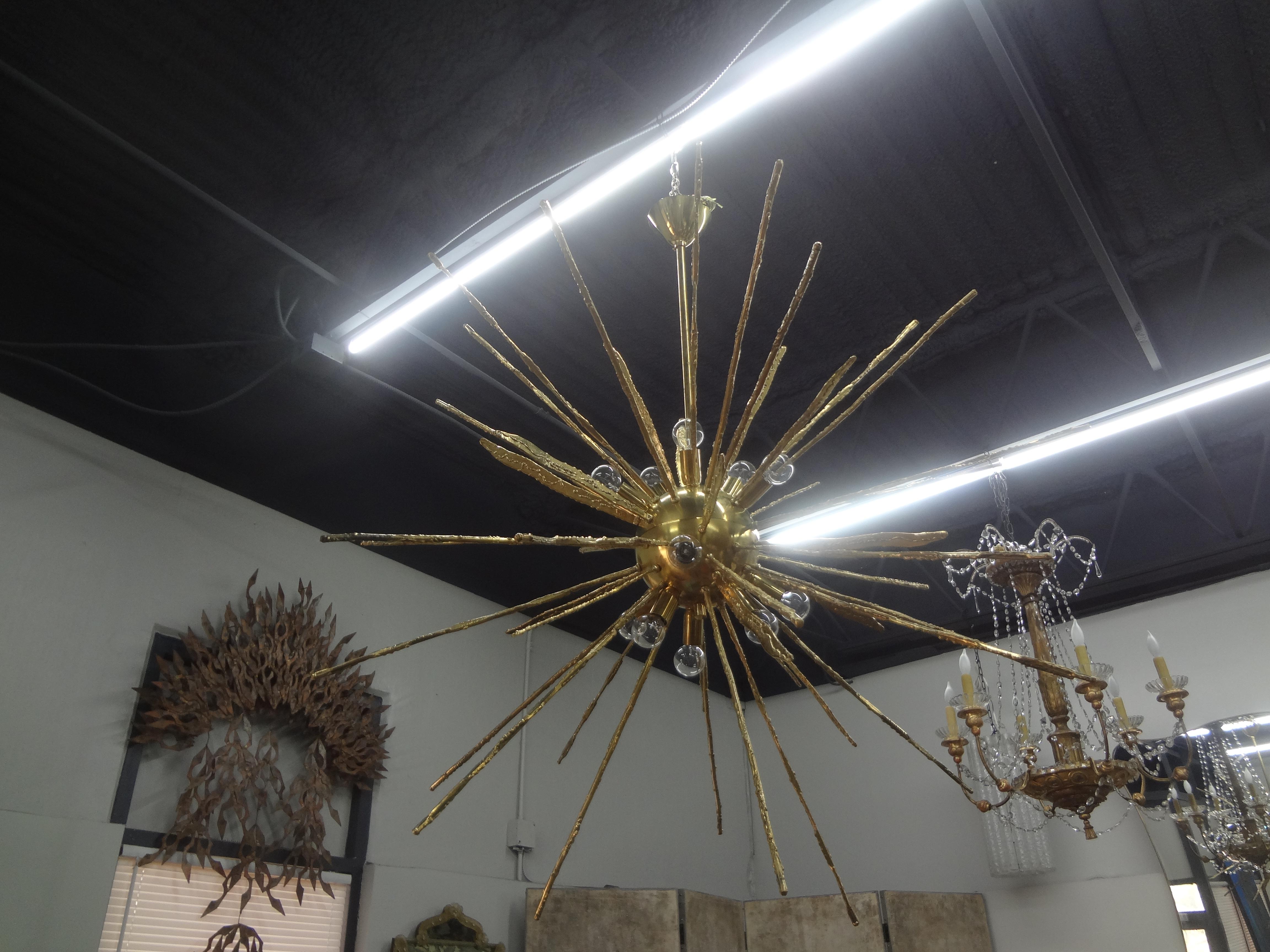 Monumental Pair Of Italian Modern Hammered Brass Sputnik Chandeliers.
This outstanding pair of Italian hand-hammered brass Sputnik or sea urchin chandeliers are newly wired with new sockets for the U.S. market. Beautifully executed in alternating